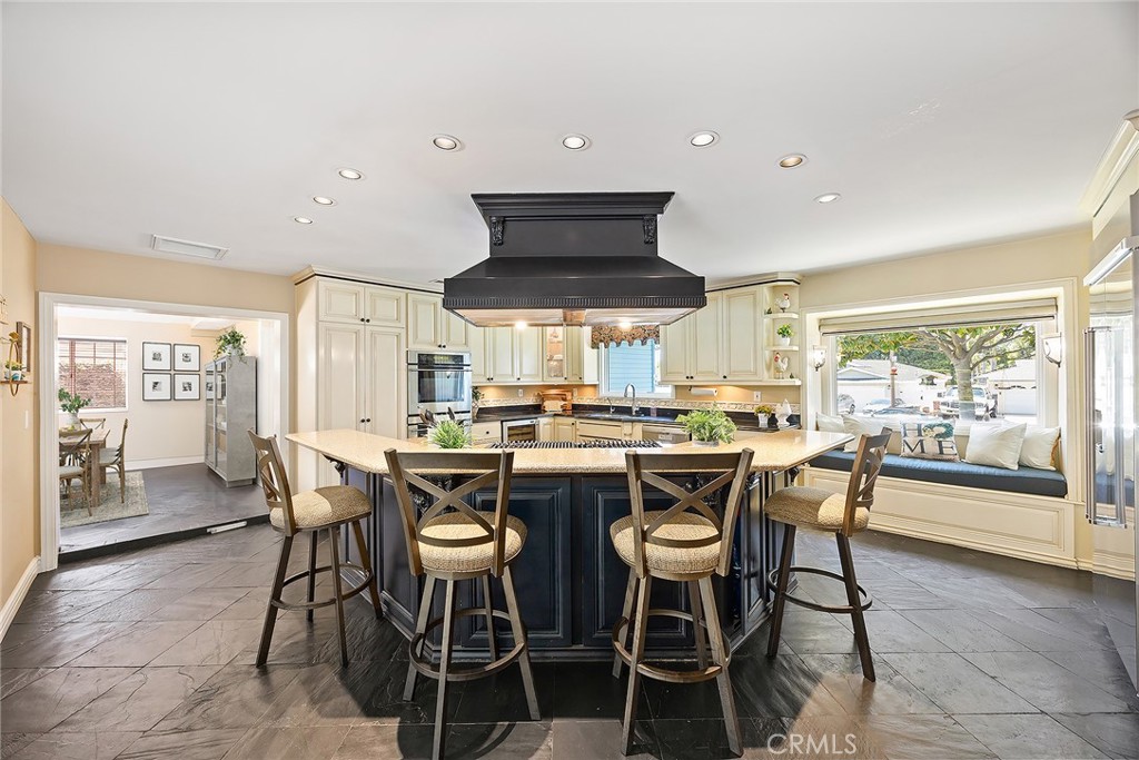 This sprawling single-story home is the perfect blend of comfort, luxury, and versatility—designed for both everyday living and unforgettable gatherings with the yard and kitchen you have been endlessly searching for! Step inside and be welcomed by the warm, inviting ambiance and a flexible floorplan ready to suit your lifestyle. At the heart of the home lies the incredible, chef-inspired kitchen outfitted with high-end appliances, including a six-burner range, double ovens, generous prep space, a casual dining island, and a cozy built-in window seat. From the living room, a wall of windows draws your attention to the backyard oasis—your own private resort. Enjoy the separate dining room which also opens to the outdoor retreat. With four bedrooms—including one currently serving as a cozy den with a fireplace, custom bookshelves, and a charming barn door—there’s plenty of room for everyone. Down the hall, find two full baths and three additional bedrooms, including an expansive primary suite with cathedral ceilings, sliding door access to a private side area, a second window seat, a spa-like bath with a freestanding soaking tub, custom vanity, and mirrored wardrobe closets. An adjacent bedroom has been professionally outfitted with custom closet organizers to accommodate any wardrobe. Get ready for your backyard paradise! Enjoy complete privacy in your own resort-style sanctuary featuring a refreshing pool with baja entry shelf, plentiful sun-drenched patio space, a cozy firepit, shady gazebo, and manicured hedges that provide a touch of elegance. Conveniently located near top-rated schools, shopping, dining, and neighborhood parks—this home truly has it all!