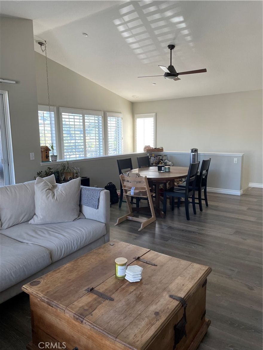 End Unit in a Great Location! This upgraded end unit has everything you’re looking for. It features laminate flooring and plantation shutters that give the space a clean, modern look. The living room is bright and spacious with vaulted ceilings, a stylish two-sided glass fireplace, and a cozy balcony, perfect for morning coffee or relaxing after work. The primary bedroom also has high ceilings, its own private balcony, plenty of space for a king bed, and a big walk-in closet. You’ll also have a two-car garage and be just a short walk from both community pools. This one is move-in ready and easy to love!