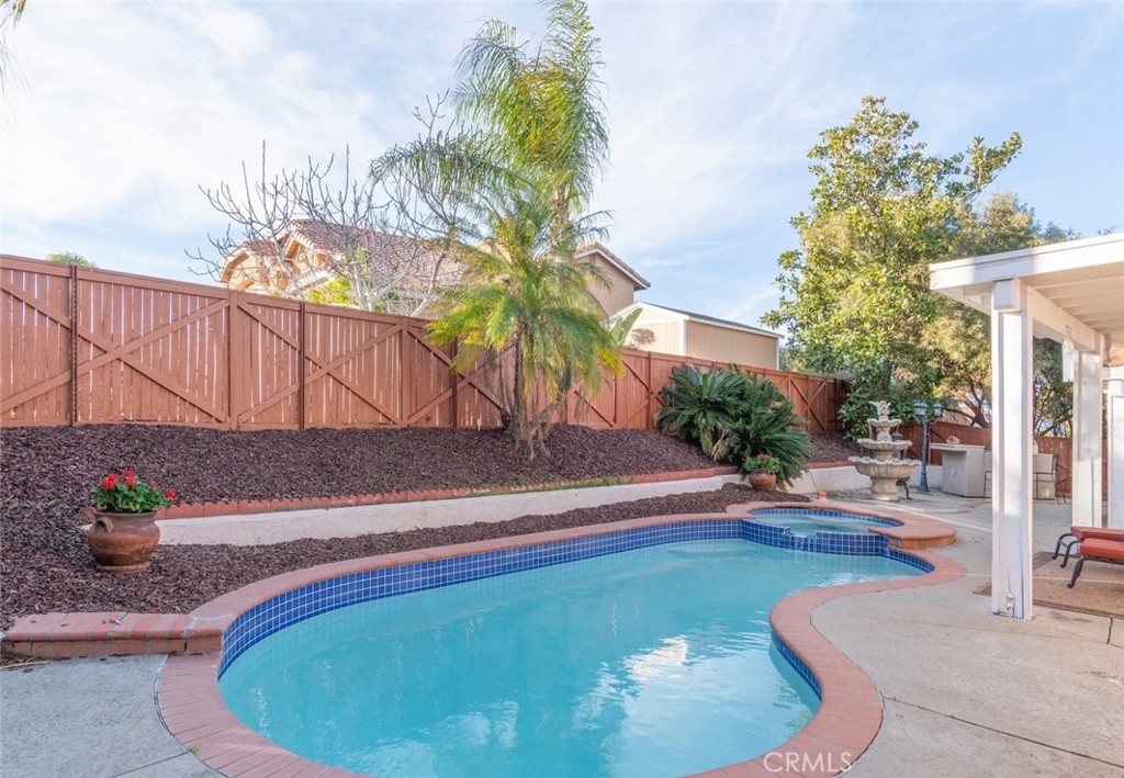 Santiago High School. Desirable single-story pool and spa home, 4 bedrooms, one wit no closet, located in south Corona with desirable schools. Recently painted inside and outside. As you enter, you can entertain guests in the formal living and dining areas. The office is near the entry-great for work-at-home. The spacious kitchen has granite countertops, a large breakfast bar, eating area, stainless steel appliances and lots of cabinets and counter space. The kitchen is open to the family room with a cozy fireplace, ceiling fan and slider to the backyard. Step outside, relax in the spa or sit by the fountain and enjoy gatherings and barbecues. Take a splash in the pool to refresh in the hotter weather. Go back inside, there are two bedrooms and a bathroom to share. The primary suite has a spacious bedroom with cozy fireplace, ceiling fan and a slider to the backyard. The primary bathroom has dual sinks, granite countertops, a jetted garden bathtub and a separate tiled shower. There is an indoor laundry room with washer and dryer included. It is bright and cheery inside. Rent includes pool service and gardener. Great location, close to shopping, schools and convenient to freeways.