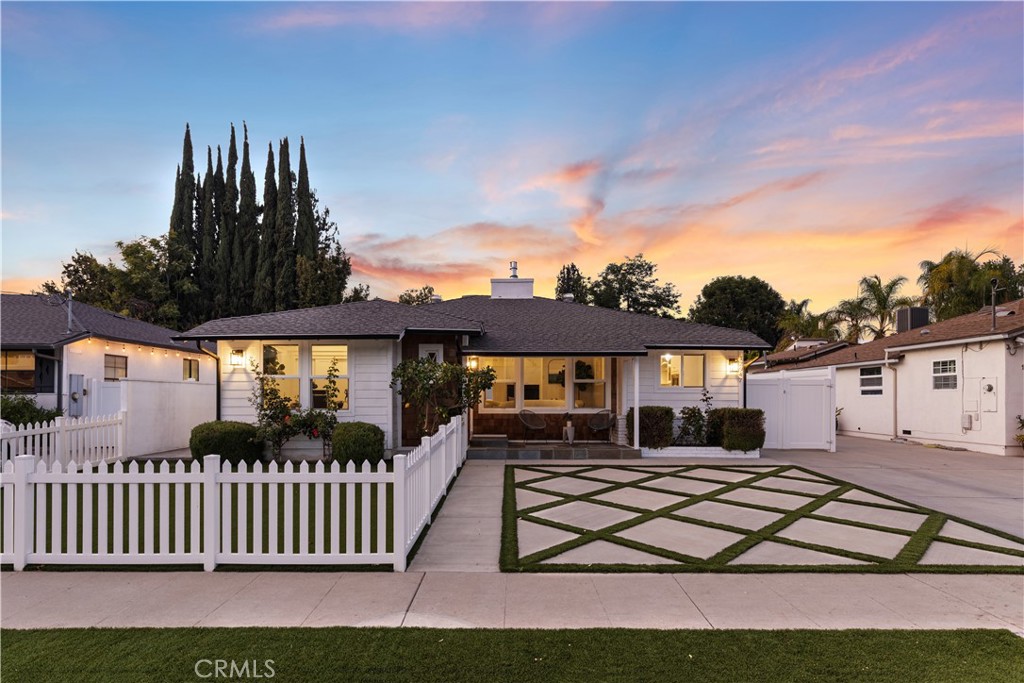 Tucked away on a quiet cul-de-sac in prime Sherman Oaks, this move-in ready home has been tastefully updated inside and out. Natural light floods the open-concept floor plan, highlighting the charming details and timeless character found throughout. At the heart of the home lies the designer chef’s kitchen, equipped with premium stainless-steel appliances, quartz countertops and a built-in breakfast nook. Open to the kitchen, there’s a formal dining room and spacious family room that boasts lofty 14ft ceiling and a Panoramic Door that seamlessly extends your living space into the backyard. Step outside to your private retreat, where you’ll find an oversized spa with a cascading waterfall flowing into the heated pool, a fully equipped summer kitchen, outdoor shower and ample patio space for relaxing or enjoying an al fresco meal. This home offers four generously sized bedrooms and three full bathrooms, including a luxurious primary suite that features a custom built-in closet and spa-inspired bathroom, complete with a soaking tub, large glass-enclosed shower and double vanity. Additional highlights include a formal living room with a cozy fireplace, dedicated laundry room, security system, smart home features (built-in speakers, Nest thermostat, etc.) and a finished detached two-car garage. This property is conveniently located just moments from Westfield Fashion Square, Ventura Boulevard’s vibrant shopping and dining scene, and top-rated public/private schools.