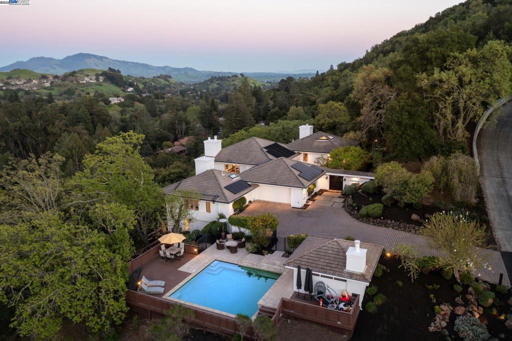 Experience ultimate luxury and privacy in this stunning Lafayette estate, just minutes from downtown and commute routes. Set on over 4 acres of pristine grounds, this 5 bedroom, 5.5 bath home spans 4,215 sq ft and showcases breathtaking views of Mount Diablo and unforgettable sunsets. From the moment you walk into the private courtyard, you will feel as if you are in one of the most prestigious resorts in the country. Relax poolside with a glass of wine or cup of coffee and take in the serene and picturesque surroundings. The pool house with fireplace is perfect for indoor/outdoor entertaining. Thoughtfully designed with two bedroom en-suites on the main floor, two more downstairs, and a private 5th en-suite ideal for guests or an au pair. The chef’s kitchen boasts Dekton and quartz counters, double oven, built-in fridge, and a large island that flows into the cozy seating area with fireplace and out to a spacious IPE wood deck through bi-fold doors. The luxurious primary suite offers French doors to a private deck and spa and stunning vistas. 800 bottle temperature-controlled wine room. Minutes to top-rated schools, trails, dining, and shopping—this is Lafayette living at its finest.