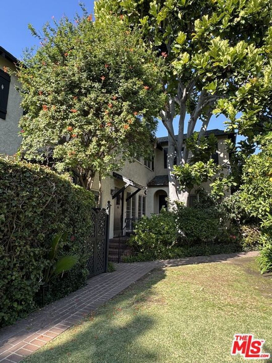 Rare and unique, built in 1925, Historic 2 BR town home in Weho. This culturally landmarked, charming garden style complex is in a gated and secure community. This 1300 plus sq ft apartment has 11 foot ceilings on first floor, Spanish stucco walls, coved ceilings, open floor plan, original hardwood floors and wrought iron railings. It is airy and light w/french windows throughout. Huge Primary Bedroom has views of a mature tree and gardens below and lends the feeling of living in a tree house! The 2nd bedroom has foliage views, custom sliding doors to a large closet and both bedroom closets have built-in dressers. Bath with tub and awesome vintage art deco tiling, pedestal sink, and inset mirrored cabinet. Kitchen has refrigerator, stove, newer dishwasher, garbage disposal, water purifier.  Unit has Ductless Heat/Air conditioning ,a separate 1car garage.  Water, trash and gardener, and building security system included. Close to both Santa Monica and Sunset Blvd and the dining, entertainment, shopping, clubs, gyms, and design that West Hollywood has to offer!