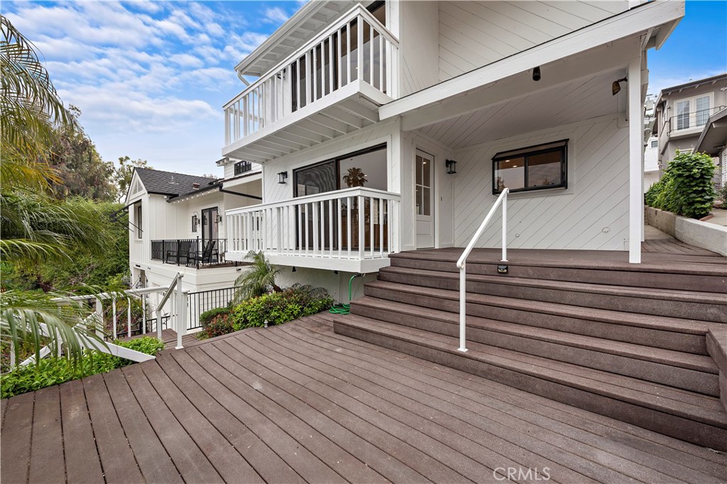 This recently remodeled front unit offers a serene coastal retreat with its prime location by the Goldenrod Footbridge and always-desirable South of PCH ease of access. Adorned by the bright and airy living space, freshly updated flooring and paint create a contemporary backdrop. The open floor plan seamlessly connects the living, dining, and kitchen areas that include updated appliances, stone countertops, and ample cabinetry - providing both style and functionality for the home chef and entertainer. A breakfast bar offers casual dining options, while the adjacent dining area is ideal for more formal gatherings. Two spacious bedrooms provide comfortable accommodations, each with their own updated bathroom for added convenience and privacy. The primary suite is a tranquil haven, featuring a luxurious ensuite bath and ample closet space. Outside, the front patio offers a peaceful oasis for enjoying morning coffee or alfresco dining in the ocean breeze. With its prime location, you'll enjoy easy access to the vibrant shops, restaurants, and beaches of Corona Del Mar Village.