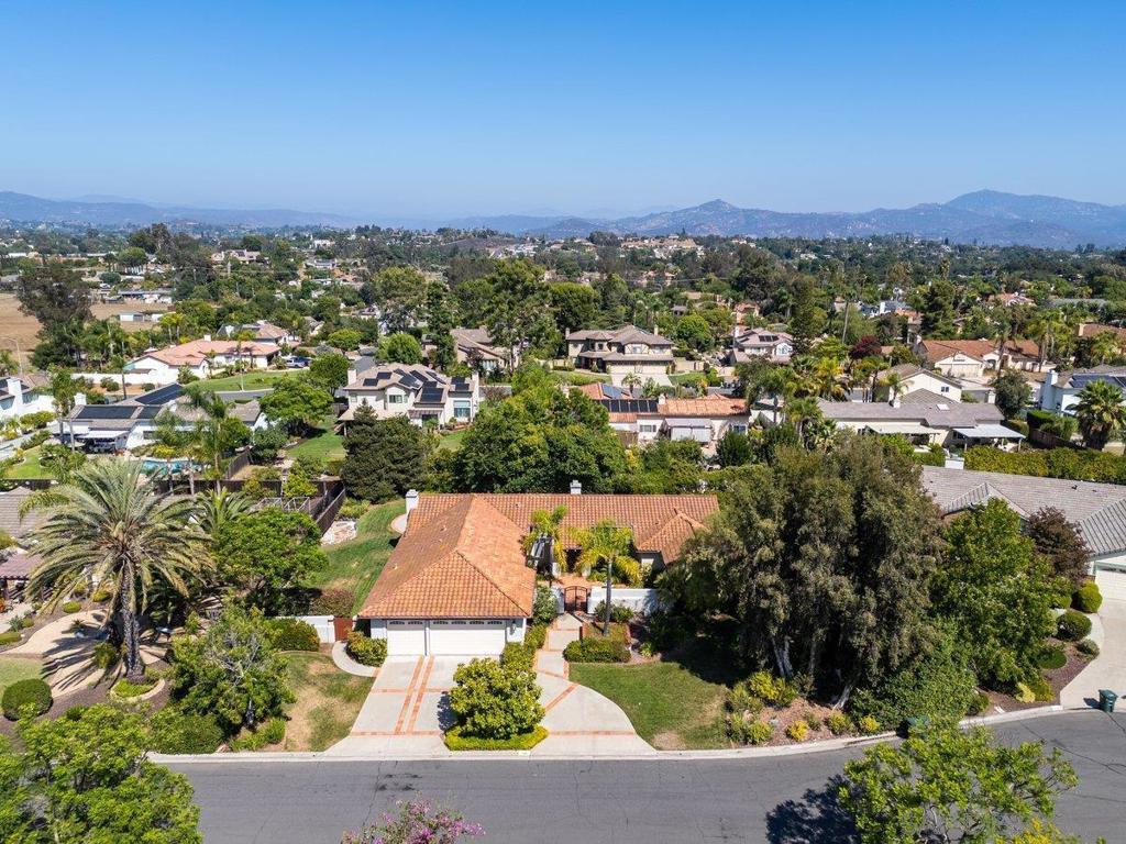 Gorgeous single-story on a peaceful cul-de-sac in a highly sought-after neighborhood. This home shows like a model with an updated kitchen featuring quartz countertops, stainless steel appliances, recessed lighting, and pendant bar lights, plus a walk-in pantry. High ceilings and a dual-sided fireplace connect the inviting living and dining rooms, while the spacious family room with its own fireplace opens to the bright kitchen. Newer windows, sliders, and plantation shutters throughout. The large primary suite offers two closets, including a walk-in, and a spa-like bath with separate shower and soaking tub. Set on nearly half an acre of usable land with a grassy play area, fruit trees, and a three-car garage. Gorgeous single story on a peaceful cul-de-sac in a highly sought after neighborhood. This home shows like a model with an updated kitchen featuring quartz countertops, stainless steel appliances, recessed lighting, pendant bar lights and a walk-in pantry. High ceilings and a dual sided fireplace connect the living and dining rooms, while the spacious family room with its own fireplace opens to the bright kitchen. Newer windows, sliders and plantation shutters are found throughout. The large primary suite is privately located on the opposite side of the home from the secondary bedrooms and offers two closets including a walk in and a spa like bath with a soaking tub and separate shower. All bedrooms have ceiling fans. Nearly half an acre of usable land provides a grassy play area, fruit trees and mature landscaping, along with a courtyard entry, gated circular driveway and three car garage. The lot offers plenty of room for a future pool or possible ADU. An exceptional home in a peaceful and serene setting.