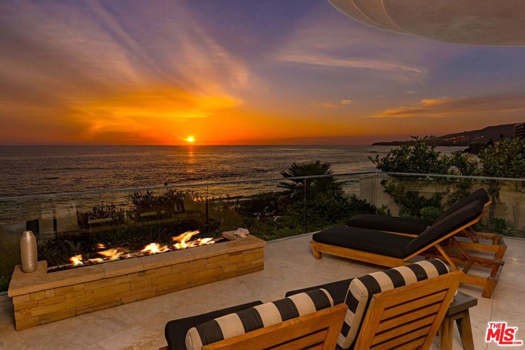 Spectacular oceanfront Laguna Beach home nestled above the bluffs of Wood's Cove. Warmth and sophistication are beautifully paired with extraordinary materials and sleek contemporary lines. Enjoy dramatic ocean and sunset views framed by floor-to-ceiling windows with sublime interior spaces spilling out onto spacious terraces to bring the outdoors in. The floor plan unfolds over two levels and includes an open concept living room with chef's kitchen and butler's pantry, formal dining room with ocean views, large media room with wet bar, wine storage, and a top-of-the-line electronics system. There are four en-suite bedrooms including the master suite with office, private terrace, fireplace, and a sizable bathroom overlooking the crystal blue ocean below. This lavishly appointed home includes controlled gated entry, Crestron whole-house system, exotic wood cabinetry, imported limestone floors, Weiland sliding doors, wood and glass interior doors, and electronic shades.