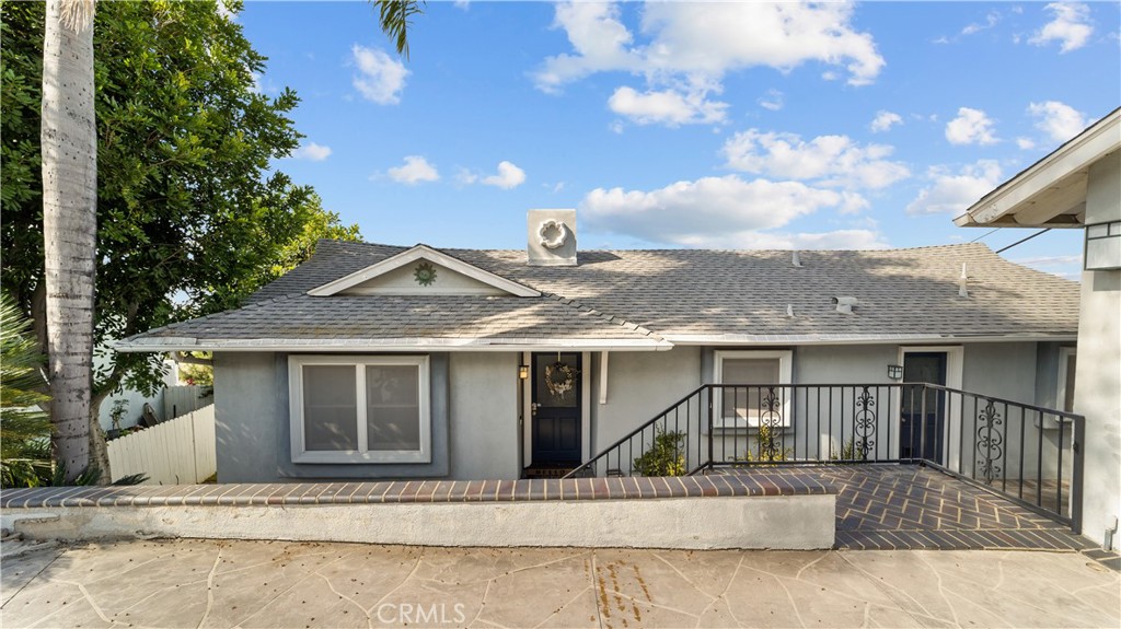 Welcome to this beautifully remodeled 3-bedroom, 2-bathroom modern home, where sleek design and stunning upgrades create the perfect blend of comfort and sophistication. The exterior immediately catches your eye with its stylish updates, including a contemporary garage door and fresh landscaping, setting the stage for what lies within. Upon entering, you're greeted by an expansive living space that showcases breathtaking city views through large, high-set windows. The living room boasts a striking black stone fireplace that adds a touch of modern elegance, perfectly complemented by rich dark hardwood floors that flow throughout the home. The kitchen is truly the heart of the home, fully upgraded and designed for both function and style. It features gorgeous granite countertops, a chic tiled backsplash, and custom wood cabinetry that provides ample storage. Stainless steel appliances shine beneath the recessed lighting, making this space a dream for both casual meals and gourmet cooking. Whether entertaining or enjoying a quiet meal, this kitchen serves as the perfect backdrop for any occasion. The primary suite offers a private and luxurious retreat with an attached, fully upgraded modern bathroom. This spa-like space is complete with a floating vanity and a beautifully tiled shower, creating a peaceful oasis for relaxation. The additional two bedrooms are generously sized, each offering comfort and versatility, perfect for family, guests, or a home office. Both bathrooms in this home have been tastefully updated with modern finishes and premium fixtures, ensuring every part of the house reflects the care and attention to detail that has gone into the remodel. One of the most captivating features of this property is the expansive backyard, centered around a large deck that provides incredible views of the city and beyond. Whether you’re hosting gatherings, enjoying an evening under the stars, or sipping your morning coffee, this outdoor space is ideal for taking in the beauty of your surroundings and soaking up the Southern California sunshine. With its thoughtful upgrades, modern design, and unbeatable views, this 3-bedroom, 2-bathroom home offers a rare combination of elegance and everyday comfort, making it a true gem. Don’t miss your chance to experience everything this stunning property has to offer!