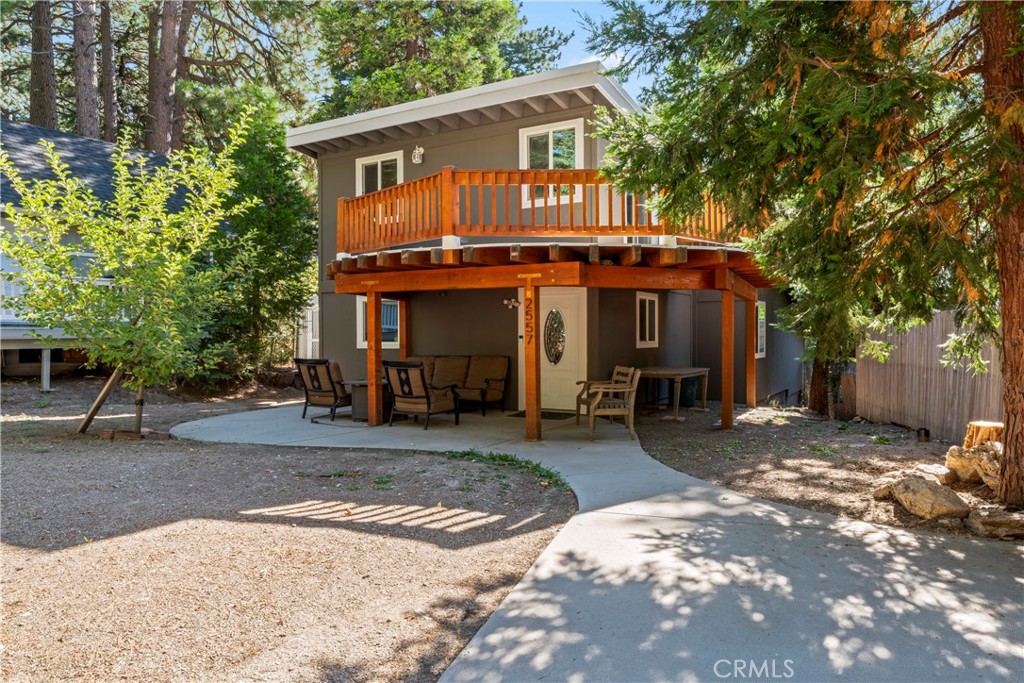 Discover your perfect mountain getaway in this level-entry home set on a spacious double lot (2557 Whispering Pines lot adds 3,314 sf for a total of 8,683 sf), tucked away from the street for extra privacy. Whether you're dreaming of full-time living or want an ideal spot for short-term rentals, this beautifully updated home offers versatile comfort and modern style. Step inside to an inviting main floor where a sleek kitchen with stainless steel appliances and granite countertops flows seamlessly into the dining and living areas. Enjoy cozy evenings by the built-in electric fireplace with decorative lighting, while custom details add warm character throughout. Find one bedroom, a full bath with stackable laundry hookups, and a flexible bonus room for work, guests, or play. Upstairs, unwind in the oversized private bedroom featuring beamed ceilings, a walk-in closet, extra linen storage, and sliding glass doors that open to a large balcony - perfect for taking in serene nature views. Fresh, neutral décor lets you add your own style, while new central heating with a smart thermostat, double pane windows, a commercial-grade roof, tankless water heater, and new exterior paint grant peace of mind and year-round comfort. Outside, the possibilities abound with plenty of parking, a covered deck entrance, an outdoor storage shed with water, and a level yard ready for a fire pit and easy entertaining under the stars. There’s even an extra lot included with the property for future expansion. Enjoy the best of mountain living just minutes from town amenities - farmer’s market, dining, library - and easy access to Hwy 330, Snow Valley ski slopes, Lake Arrowhead, and Big Bear. Embrace a lifestyle of relaxation and adventure in this inviting home that truly has it all.