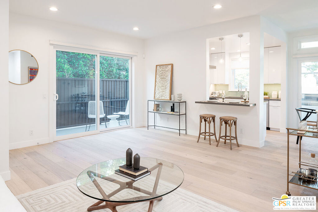 Pet-Friendly High End 2B+2B in West Hollywood Off Melrose Place. Discover boutique high-end living in this meticulously crafted 2-bed, 2-bath residence within an exclusive eight-unit luxury building, fully renovated in 2020. Positioned above grade on the first floor with tall ceilings for an airy, open feel. Chef's Kitchen-Glass tile backsplash, KitchenAid stainless steel appliances (refrigerator, a GAS oven/stove with hood, dishwasher), quartz countertops, and a waterfall island/bar that flows into a spacious great room with pendant and recessed lighting. Spacious Great Room-Open to the kitchen and dining area, with flexible furniture layout options. Sliding glass doors lead to two separate decks for indoor-outdoor living. Primary Suite Retreat-Generously sized to fit a king bed with side tables, plus room for a small sofa and armoire. Includes a custom walk-in closet and a spa-style en suite bath.Second Bedroom-Generous size bedroom with a custom built-in closet and easy access to the second full bath.Premium Finishes-Hardwood floors throughout, tiled bathrooms, dimmable recessed lighting through out, blackout blinds in bedrooms, central A/C & heat, a large in-suite washer/dryer, coat closet, and hallway cabinets for linens or general storage.Private Outdoor Living-2 private outdoor areas: A balcony off of the dining room accessed from sliding doors overlooking tree lined Orlando and a private deck off the living room accessed by sliding doors.Modern Comfort & Smart Tech-Nest thermostat, digital locks, Ring doorbell, controlled access entrance with a video intercom, in-unit alarm system, and remote control for building entry, garage access, lighting, and your own front door lock/unlock directly from your phone.Amenities-In the back of the building there is a BBQ area, dog grooming station, fire pit, and a bamboo-lined outdoor lounge perfect for entertaining. Fitness center with Peloton, elliptical, and light weights. Security cameras throughout the property.Parking:-Two assigned parking spaces available in gated parking area below building. EV charger may be available.Unbeatable Location-Just 50 meters from Melrose Place steps from trendy cafes, juice bars, restaurants, yoga studios, gyms, and the local farmers market.Landlord pays for water, trash, landscaping. Minimum 1 year lease .