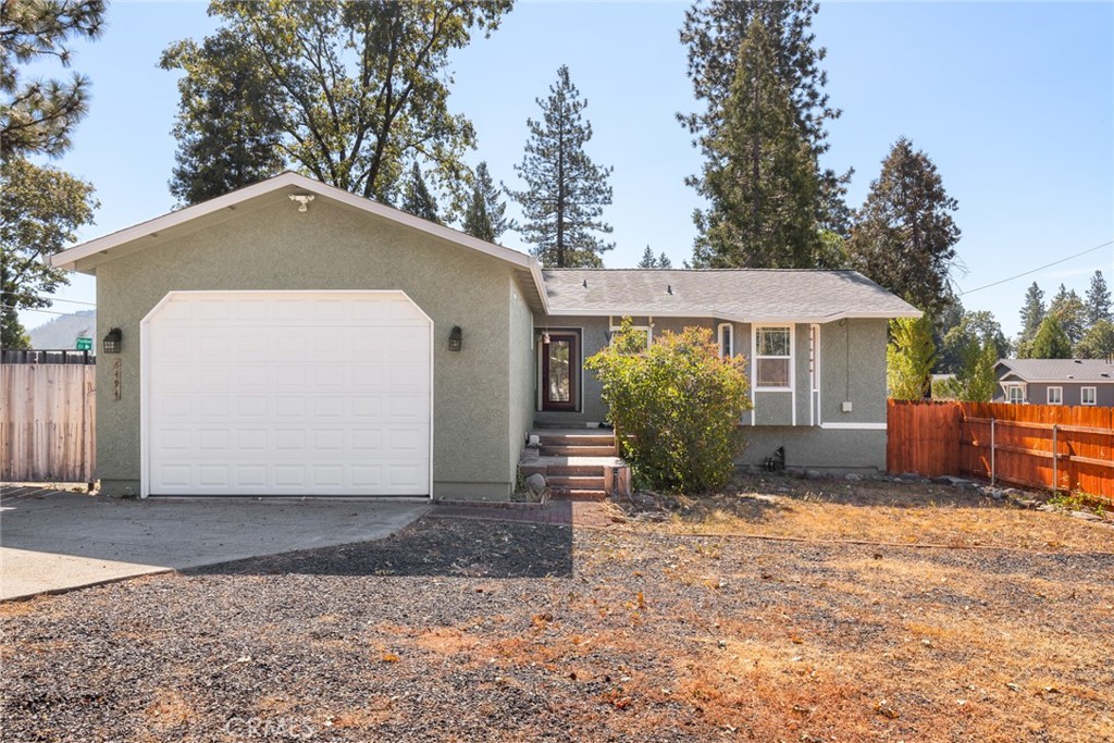 Welcome to this charming Magalia home, offering comfort and functionality on a well-improved lot. The exterior showcases a fenced yard with a double gate, an extended driveway, dog run, expansive decking, and a concrete patio perfect for outdoor living. Full RV hookups with sewer, water, and electrical make hosting or traveling a breeze. In addition to a woodshed, you’ll find a 9x20 carport, a shipping container, and a two-story unfinished bonus building complete with a loft and patio—ideal for storage, hobbies, or future projects. Inside, the home offers 2 bedrooms, 2 baths, an indoor laundry area, and a versatile bonus room perfect for an office, playroom, or extra storage. (The upstairs bonus space and laundry add approximately 130+ sqft not included in the listed square footage.) Warm, inviting details include vaulted ceilings, skylights, rich wood trim, a cozy wood stove with brick surround, wood flooring, and a stylish barn door accent. The attached two-car garage is designed with convenience in mind, featuring an oversized 10’ door. This property blends comfort, functionality, and opportunity—ready to welcome its next owner.