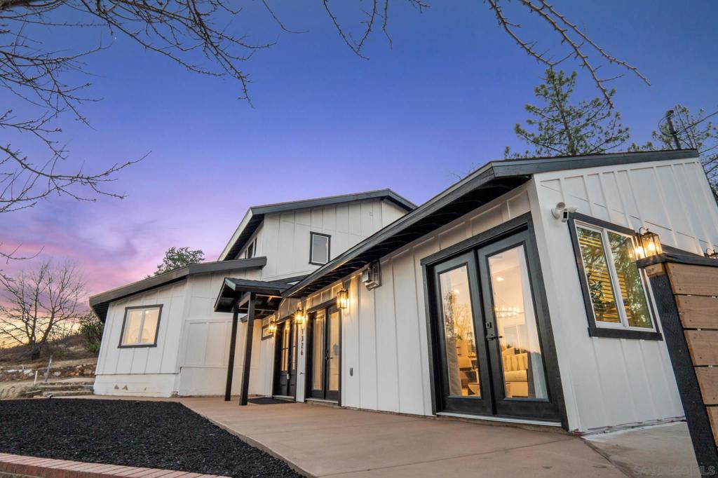 Welcome to 1326 Farmer Road, a meticulously reimagined mountain sanctuary nestled just five minutes from the charming historic town of Julian. Perched high on a private hillside and enveloped by towering pines, this one-of-a-kind estate offers the ultimate blend of luxury, privacy, and timeless natural beauty. Originally constructed in 1983, this extraordinary residence has been rebuilt from the ground up with over 85% of the structure redesigned and modernized to meet the highest standards of luxury living. Whether you’re seeking an elegant second home, a serene primary residence, or a high-performing luxury short-term rental, this home delivers unmatched versatility and sophistication. Crafted for both beauty and resilience, the exterior showcases Hardie Fiber Cement siding—fire-resistant and impervious to weather, termites, and woodpeckers—ensuring long-term peace of mind. Step inside to discover a show stopping chef’s kitchen, outfitted with a 48” Dacor range with double convection ovens and a 42” Thermador commercial-grade refrigerator, perfect for culinary excellence and entertaining on a grand scale. The primary suite is a private haven, complete with a dedicated retreat space, direct access to a tranquil patio, and a spa-inspired en-suite bathroom featuring a luxurious wet room with soaking tub, rainfall shower, LED-lit mirrors, and a private laundry area. Upstairs, three additional bedrooms, two baths, a loft, and a second laundry room provide generous accommodations for family and guests. This beauty has it all, come experience. Welcome to 1326 Farmer Road, a meticulously reimagined mountain sanctuary nestled just five minutes from the charming historic town of Julian. Perched high on a private hillside and enveloped by towering pines, this one-of-a-kind estate offers the ultimate blend of luxury, privacy, and timeless natural beauty. Originally constructed in 1983, this extraordinary residence has been rebuilt from the ground up with over 85% of the structure redesigned and modernized to meet the highest standards of luxury living. Whether you’re seeking an elegant second home, a serene primary residence, or a high-performing luxury short-term rental, this home delivers unmatched versatility and sophistication. Crafted for both beauty and resilience, the exterior showcases Hardie Fiber Cement siding—fire-resistant and impervious to weather, termites, and woodpeckers—ensuring long-term peace of mind. Step inside to discover a show stopping chef’s kitchen, outfitted with a 48” Dacor range with double convection ovens and a 42” Thermador commercial-grade refrigerator, perfect for culinary excellence and entertaining on a grand scale. The primary suite is a private haven, complete with a dedicated retreat space, direct access to a tranquil patio, and a spa-inspired en-suite bathroom featuring a luxurious wet room with soaking tub, rainfall shower, LED-lit mirrors, and a private laundry area. Upstairs, three additional bedrooms, two baths, a loft, and a second laundry room provide generous accommodations for family and guests—easily expandable to five or six bedrooms with thoughtful reconfiguration. The expansive great room is anchored by a designer gas fireplace with blower, opening through French doors to sweeping views of the surrounding forested hills. An oversized dining sidebar makes entertaining effortless, setting the stage for unforgettable moments in every season. Every detail has been considered—new roof, skylights, upgraded electrical and panel, multi-zone HVAC, and more—delivering exceptional comfort, efficiency, and elegance throughout. Experience refined mountain living in one of Julian’s most exclusive offerings. Whether you’re seeking a peaceful escape or a premier income-producing asset, this home checks every box.