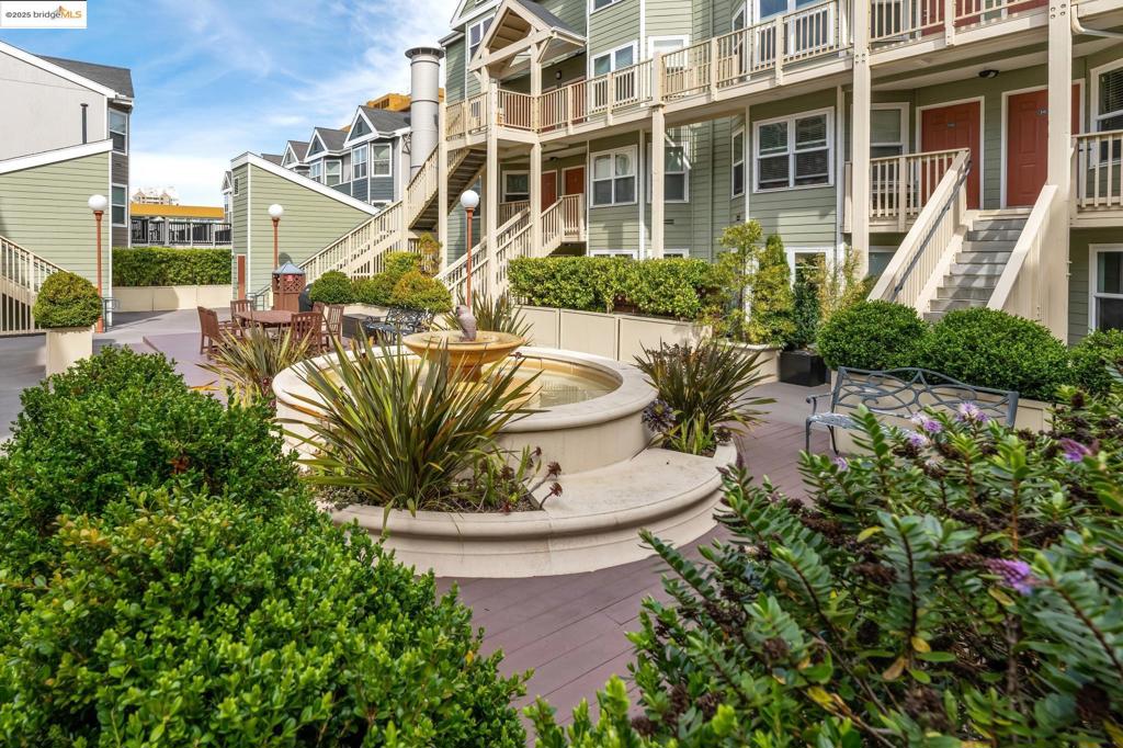 Rarely available modern condo with a versatile den/flex space, located directly across from San Francisco’s iconic Painted Ladies at Alamo Square Park on the border of Hayes Valley. This home combines the charm of a historic neighborhood with the convenience of a newer building in a secure, gated community. The unit offers no steps to entry, wide-plank hardwood floors, an upgraded kitchen with granite counters, in-unit washer/dryer, and a bright living/dining area. The flexible den works perfectly as a home office, lounge, or guest stay. The generously sized bedroom includes a floor-to-ceiling closet and opens directly to a private patio. One dedicated garage space is included—ideally located next to the elevator that takes you straight to the condo level. Community amenities feature a lush courtyard with a fountain and BBQ area, secured mailboxes, and a parcel room. With a Walk Score of 96 (Walker’s Paradise), plus Excellent Transit and Very Bikeable ratings, enjoy unmatched access to Hayes Valley dining, shops, cafes, and public transportation. Multiple Muni lines within one block provide a 20-minute commute to the Financial District, with nearby BART stations offering citywide and Bay Area connections. Exceptional condo with private patio and parking in the heart of SF!