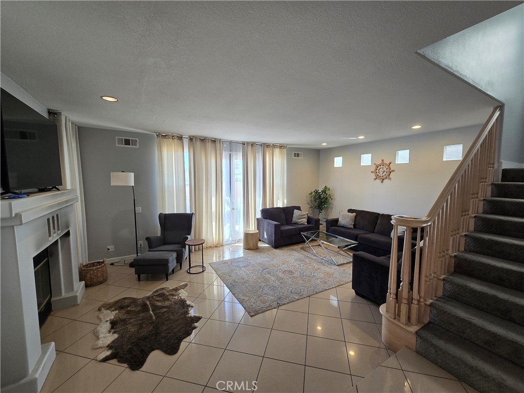 This beautifully upgraded, fully furnished home is in a prime Huntington Beach location—just a short walk to Huntington Beach High School and the sand. A true coastal paradise, this property is gated for safety and offers a charming outdoor area perfect for enjoying the ocean breeze.
Upon entry, you’ll be greeted by soaring ceilings in the living room, complete with a cozy fireplace and adjoining dining area. The upgraded kitchen features sleek quartz countertops, ample cabinet space, and is conveniently located near a second, larger dining area with its own fireplace. The attached two-car garage provides easy access and additional storage.
Upstairs, you’ll find two spacious bedrooms, each with access to a shared bathroom—one with a balcony and the other with a large closet. A comfortable family area separates these bedrooms from the luxurious primary suite, which boasts a fireplace, generous extra space, a private balcony, walk-in closet, and an ensuite bathroom with both a soaking tub and separate shower.
The crown jewel of this home is the expansive rooftop balcony with breathtaking ocean and neighborhood views—perfect for entertaining or enjoying a private sunset.