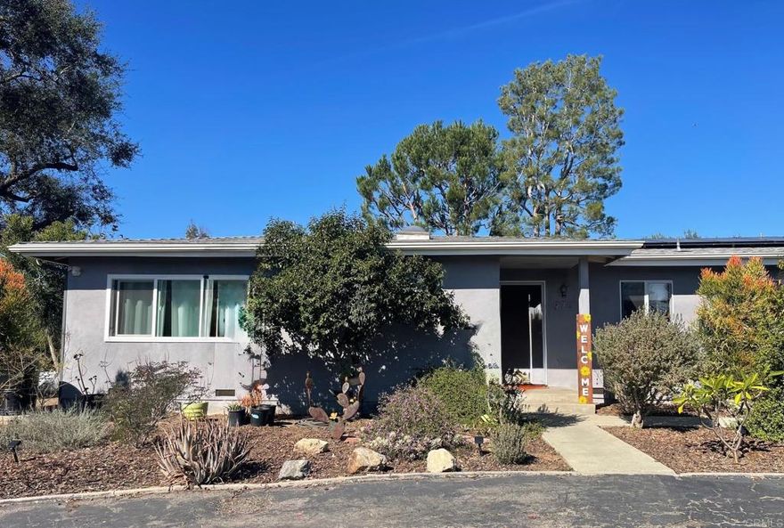 This single-story Fallbrook home offers the best of both worlds—classic country character with thoughtful modern updates. With 4 bedrooms and 3 baths, it’s the kind of home that easily fits a multigenerational lifestyle or anyone craving space and connection. Sunlight fills every corner, creating a bright, welcoming feel from the moment you walk in. The original part of the home showcases timeless wood floors and a cozy galley kitchen with a breakfast bar that opens to a warm, inviting living area—perfect for gathering with friends and family. The newer addition brings a spacious primary suite with a generous walk-in closet, plus a huge family room anchored by a wood-burning fireplace and beautiful acacia engineered wood flooring. With owned solar, tankless water heater, and a new A/C system installed in 2025, this home blends rustic charm with everyday comfort.  Outside, 1.35 gently sloping acres offer room to breathe, with majestic oak and pine trees and a variety of fruit trees—apple, fig, lemon, grapefruit, and guava and drought tolerant succulents, nopal, Jacaranda and plumeria. The property’s “L” animal zoning means there’s space for horses, and several fenced enclosures are ready for chickens. There’s even room for your RV, garden, or whatever country-living dreams you have in mind. Convenient location close to the 76 & 15 freeways allows easy access to mountains, desert and beaches and shopping and dining in friendly downtown Fallbrook. Come see this peaceful Fallbrook retreat—it's ready to welcome you home.