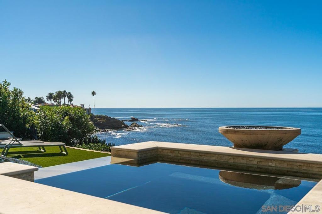STUNNING LA JOLLA OCEANFRONT ESTATE! Located on the prestigious “Street of Dreams”. Enter this Sophisticated and timeless CONTEMPORARY home through Private Gates to 5,139 sf. A Smart home with 22 ft dramatic entry. Open Floor plan with L/R, D/R, Gourmet Chefs Kitchen w/unobstructed views of Cove & white water waves. Captivating Beauty that only the front row can offer. Use the elevator or elegant grand staircase to the glamorous Primary Suite w/ the European Bathroom of your dreams & w/ ocean views. A rare infinity Oceanfront Pool. Breathe clean ocean air, enjoy sunsets, & experience nature at its finest. Walk the coastline to the village.