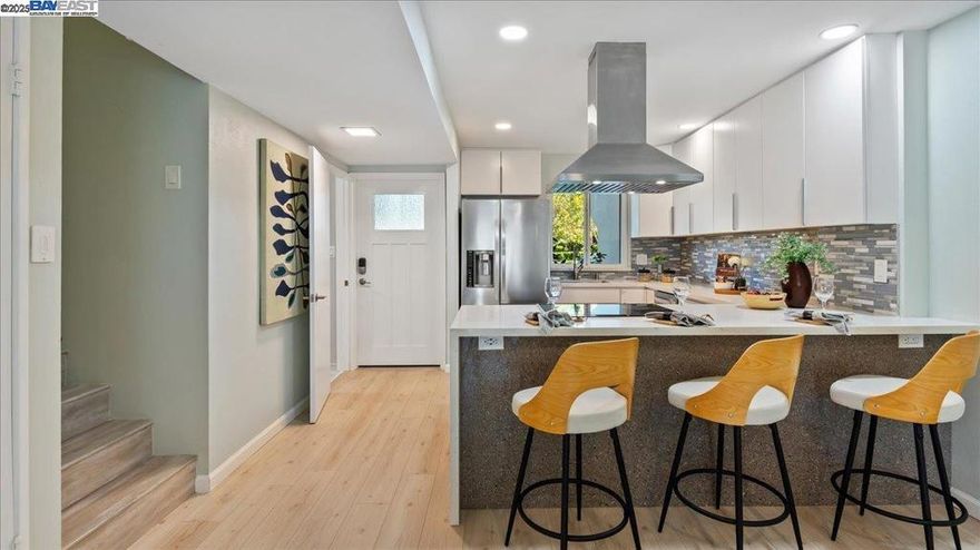 Step into sophistication at 3027 Alta Vista. This exquisitely updated 2-bed, 2-bath home offers 1,180 square feet of luxurious living space on two levels. Every corner of this home exudes elegance and modern flair, thanks to meticulous improvements. The kitchen is a masterpiece of design, featuring chic quartz countertops with a waterfall edge, all-new stainless steel appliances, and a glossy glass backsplash that complements the open floor plan.  The bathrooms are a sanctuary of style, showcasing marble walls, glass shower stalls, and upstairs  are dual sinks. Bidet toilets and refined vanities enhance the bathrooms' elegance. Both bedrooms feature custom closet and clothes storage systems. Throughout the home, water-resistant laminate flooring pairs beautifully with the tiled bathroom accents. The living room, with its wood-burning fireplace, boasts a new surround with stone mantel and base along with ceramic tiles, adding a touch of warmth. Smart home features include a Nest heating control and a Bluetooth Halo lighting system. The outdoor courtyard beckons with new pavers and fruit trees, while the 2-car garage is equipped with an EV car charger. Enjoy access to a communal pool and playground. Nearby are excellent schools, ferry to SF, lush waterfront parks and shopping.