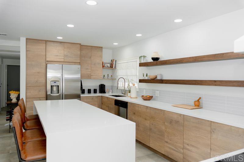 Paid Solar! Discover resort style living in this newly remodeled modern - European inspired home with a private pool! Nestled in one of San Diego's most desirable Suburban neighborhoods of San Carlos! Steps away from top-rated schools, shopping and commuter routes in SD. Minutes from Lake Murray's tranquil waters and the scenic trails of Cowles Mountain! Featuring an inviting bright open kitchen layout with stunning custom wood cabinets, quartz countertops, a nine foot island with tons of storage and new stainless steel appliances, perfect for hosting large gatherings! Enjoy gorgeous new Spanish tile floors throughout the home, and a elegant tiled fireplace in family room. Rejuvenation awaits in both bathrooms with luxury fixtures and spa style details. Relax or dine in your 200 sqft bonus sun room that opens up to your own private backyard oasis with a sparkling pool! Discover endless possibilities with the concrete courtyard and new raised garden bed. Don't wait - this is the home you've been waiting for! Schedule a private showing today and fall in love.