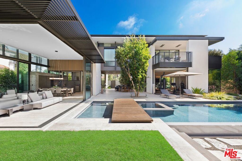 Acclaimed architect Grant Kirkpatrick's detailed design. This is a stunning achievement that is deceptively sophisticated with understated opulence. Seamless space that comfortably flows for today's modern lifestyle. The open air outdoor living space is an instantaneous vibe of relaxation and serenity. Luxurious fixtures and finishes abound. The highest quality materials crafted by the most dedicated workmanship. The office is flooded with natural light, yet shielded by a robust concrete wall that provides ample privacy. The chevron patterned wood floors create a smart, refined board-room like area. A discrete separate entrance enables an efficient "work-from-home" environment, complete with a casual outdoor area that accommodates multiple person meetings, well away from the rest of the house. Take the floating stairs, or the elegant elevator down to the incredible entertaining space. The massive movie theater presents a "better-than-cineplex" experience. The super cool bar and the ample space for a ping-pong or pool table completes the fun nightclub vibe. All of this great space overlooks the extraordinarily rare professional-size basketball court. Truly unique, the indoor half-court can train pro players, or a dedicated fan who wants to be one. It goes without say that the court can also serve to host fundraising events or large-scale parties. Just off the center courtyard is the highest-caliber gym. This workout space is supported by a cold-plunge pool, an infrared sauna, as well as a sand-training pit with an outdoor shower. The ultimate work out for the ultimate fitness athlete. The premiere suite has spacious closets for a bespoke shoe collection or hanging an endless array of suits and gowns. It also offers a huge covered patio for enjoying our perfect weather. The generous application of warm natural woods with exciting natural stone, all illuminated by a steady stream of natural light, make this, naturally, a true masterpiece. Utter perfection in the most prime location. Serene and sexy architecture. Sublime luxury. An athlete's dream, an entertainer's delight.