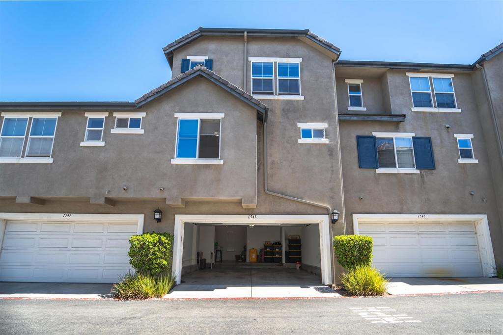 Welcome to this beautifully updated tri-level townhome located in the highly sought-after Greystone Community of Eastlake, Chula Vista. This spacious 3-bedroom, 3-bath residence offers a versatile floor plan featuring dual primary suites, perfect for multi-generational living or guest accommodations. Step inside to find freshly painted interiors, rich wood flooring, and an inviting open layout. The upgraded kitchen boasts granite slab countertops, crisp white cabinetry, and stainless steel appliances—including a dual oven—ideal for both everyday living and entertaining. The oversized two-car garage includes a convenient laundry area, providing ample storage and functionality. Enjoy resort-style community amenities, including a sparkling pool and hot tub, a welcoming clubhouse, and beautifully maintained parks. With its prime Eastlake location, this move-in ready home combines modern updates, comfort, and community living at its finest.
