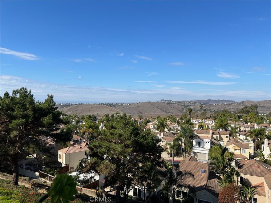 Experience expansive ocean, mountain, and valley views from this beautiful townhome. Originally built as a two-bedroom residence, it now features an additional loft—accessible by a spiral staircase—currently utilized as a versatile bonus room or office and noted as a potential third bedroom. The home offers two full bedrooms and two full baths, a well-designed galley kitchen, and a deck perfectly positioned to take in the stunning vistas. An exceptional opportunity!