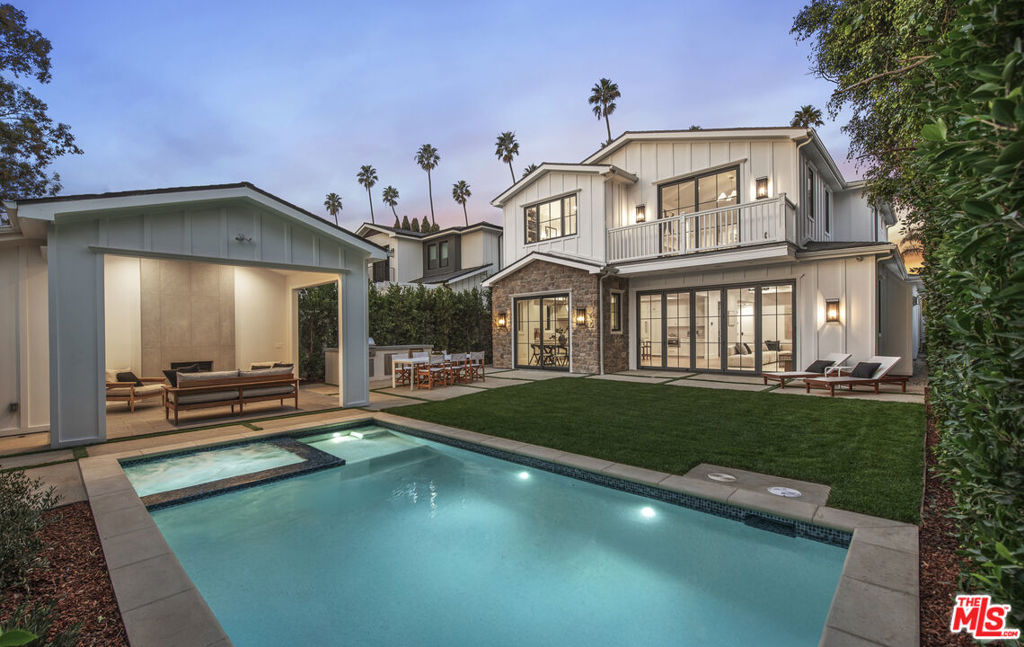 Rising from one of Brentwood's most coveted streets, this brand-new five bedroom residence introduces a fresh interpretation of California living. Offering an impressive 4,209 square-feet of living space behind a gated driveway, the design melds timeless style with thoughtful functionality. The stone and siding exterior lend alluring appeal, while lush hedges frame the property creating a natural sanctuary. Inside, the interior reveals an artful composition of spaces with high ceilings, home automation, and meticulously curated finishes. The great room serves as the centerpiece of the home, harmoniously connecting the gourmet kitchen and family room in a flowing, light-filled space with direct access to the backyard. At its heart, the kitchen stuns with its expansive stone island, cozy breakfast nook, professional-grade Wolf range, and SubZero appliances. A well-appointed butler's pantry, equipped with a wine fridge, further enhances the kitchen's utility, and provides convenient access to the dining room. A dedicated office, formal living room and bedroom suite complete the main level. Ascend a double-height stairway to the upper level, where a skylight-lit hallway leads to a convenient laundry room and four bedroom suites. The primary suite presents a tranquil sanctuary, incorporating vaulted ceilings with architectural wood details, a gas fireplace, and a private balcony overlooking the beautiful backyard. Its spa-inspired bathroom features dual sinks, makeup vanity, glass-enclosed shower, and a luxurious soaking tub. Outside, the backyard mirrors the home's refined design with a covered cabana with a half bath accompanying the swimming pool and spa, while a dedicated outdoor kitchen and dining terrace create an additional living and entertaining space. Parking accommodations for four vehicles within the 2-car garage and driveway are secured behind an automatic gate. This residence stands as a sophisticated interpretation of contemporary California living, ideally situated just moments from fine dining, shopping, and entertainment, with close access to the premier amenities of both Brentwood and Santa Monica.
