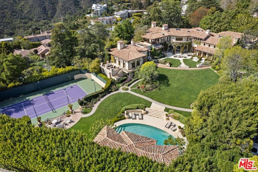 An estate of incomparable grandeur and legacy, this one-of-a-kind Villa is situated on a premier Pacific Palisades street, boasting ~2 acres of immaculate grounds with its own private tennis court. Designed by world-renowned architect Richard Landry, this estate showcases ultimate privacy, set behind large double gates and mature hedging on one of the largest lots in the Riviera. This estate consists of approximately 17,000 square feet of palatial living. Showcasing unparalleled design, this masterpiece is accented with the finest materials. This beautifully crafted Italian compound boasts 8 bedrooms, 15 bathrooms with an expansive floor plan showcasing grand scale, design and functionality. Drenched in natural light, the main home includes elaborate details and finishes with European imported stone, coffered and vaulted beamed ceilings, and rare biblical stone from Jerusalem. Highlights on the main level include a bright solarium, a luxury dining room with access to the grand chef's kitchen that exudes opulence with professional grade appliances, two islands with seating and a large pantry. Upstairs, the lavish primary suite includes a fireplace, sitting area, and private balcony that overlooks the grounds and has gorgeous ocean and canyon views. The spa-like bathroom includes dual layout, each having their own private space with showroom style walk-in closets. The home boasts multiple recreational areas including a screening room, large sitting/playroom upstairs, and a dedicated game room on the main level. Outdoor entertainment at its finest, the sizable backyard includes a newly restored lit private north/south tennis court with viewing area, putting green, built-in BBQ with dining and bask in the large pool/spa in the sun all day. The property also offers a 2-story, private 1-bedroom, 2-bathroom guest house that includes a full kitchen. This once-in-a-generation estate is one that you do not want to miss.