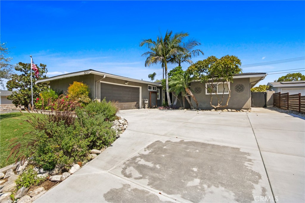 Lovely 3-bedroom 2-bath home features an open floor plan, recessed lighting, granite counter tops, wood laminate flooring, ceiling fans, central air & heating, plus an attic fan. The kitchen opens to the dining area and the living room. The latter has a fireplace. The master bedroom has two closets. There is a covered patio just off the living room. The stackable washer & dryer hookups are located in the kitchen area, and there are also hookups in the 2-car oversized garage.