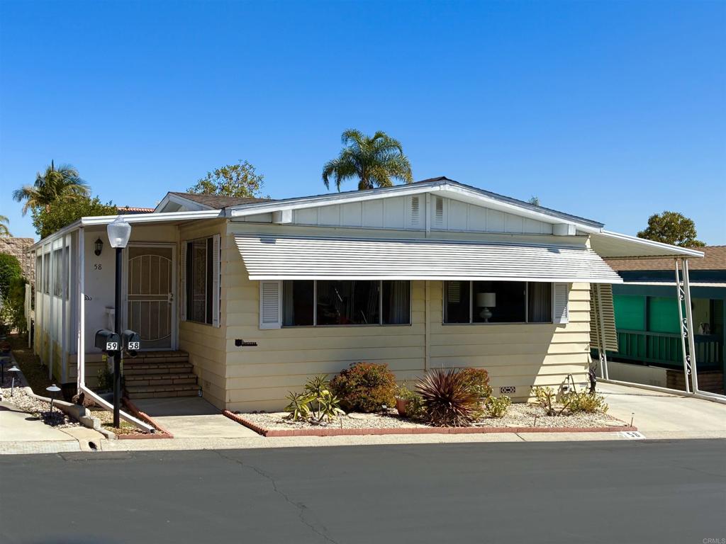 Lovely well cared for and updated home located in a 55+ resort style community with many amenities and city rent control! This home features waterproof Luxury Vinyl Plank floors throughout, as well as updated interior paint, molding, and fixtures. The Island Kitchen features new quartz counter tops, backsplash, and all newer appliances (with the exception of the oven.) This open floor plan has Separate Living and Family rooms providing plenty of space for leisure or entertaining. A solar tube in the Family room helps make this home feel bright and cheerful. The Primary Suite has a door that leads out to a raised garden bed and private back patio. There is Central A/C in addition to ceiling fans located in both bedrooms and the Living and Family room for a total of four. An oversized enclosed porch offers additional usable space not accounted for in the 1440 Sq.Ft.; This space makes a great sitting room, office, exercise or hobby room. The exterior offers TWO storage sheds for even more storage space. Rancho Vallecitos is a beautiful, 5-Star, resort style community for persons 55 years of age and over (2nd resident can be age 45+). One of the most beautiful manufactured home communities in California, Rancho Vallecitos has great views that can be enjoyed throughout the community, plus many social activities and amenities. Amenities include a clubhouse/recreation building, pool & spa, library, gym, billiards room, card tables, game and craft room, putting green, dog park, RV parking for an additional cost, and so much more! Space rent is $716.34 and park is under city rent control.