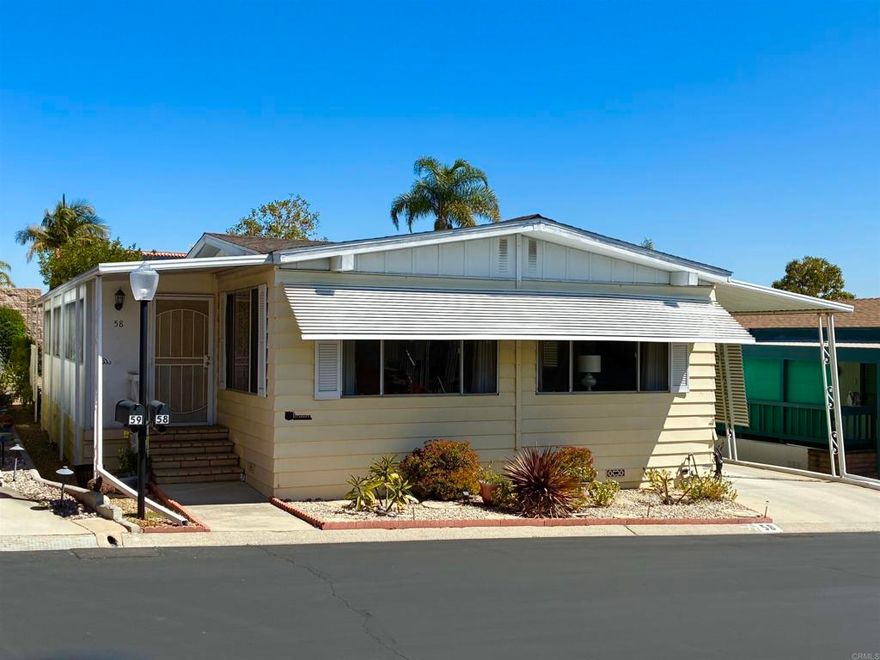 Lovely well cared for and updated home located in a 55+ resort style community with many amenities and city rent control!  This home features waterproof Luxury Vinyl Plank floors throughout, as well as updated interior paint, molding, and fixtures.  The Island Kitchen features new quartz counter tops, backsplash, and all newer appliances (with the exception of the oven.)  This open floor plan has Separate Living and Family rooms providing plenty of space for leisure or entertaining.  A solar tube in the Family room helps make this home feel bright and cheerful.  The Primary Suite has a door that leads out to a raised garden bed and private back patio.  There is Central A/C in addition to ceiling fans located in both bedrooms and the Living and Family room for a total of four.  An oversized enclosed porch offers additional usable space not accounted for in the 1440 Sq.Ft.; This space makes a great sitting room, office, exercise or hobby room.  The exterior offers TWO storage sheds for even more storage space.   Rancho Vallecitos is a beautiful, 5-Star, resort style community for persons 55 years of age and over (2nd resident can be age 45+). One of the most beautiful manufactured home communities in California, Rancho Vallecitos has great views that can be enjoyed throughout the community, plus many social activities and amenities. Amenities include a clubhouse/recreation building, pool & spa, library, gym, billiards room, card tables, game and craft room, putting green, dog park, RV parking for an additional cost, and so much more! Space rent is $716.34 and park is under city rent control.