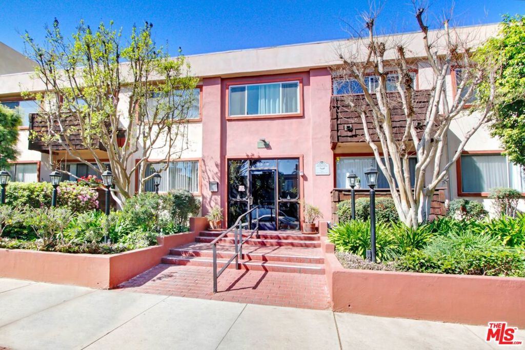 Bright and airy second floor condo with excellent flow and a relaxing view of the community pool. The kitchen is equipped with stainless steel appliances including refrigerator dishwasher mounted microwave and a breakfast nook. With only one shared wall this home offers added peace and privacy. Interior features include wood laminate and tile flooring throughout along with smooth ceilings for a clean modern look. The balcony overlooks the pool and courtyard providing a calm top floor setting. The gated pet friendly community includes a pool barbecue area fitness room and clubhouse. Two covered tandem parking spaces are included. Conveniently located near the 405 and 101 freeways for easy access throughout Los Angeles