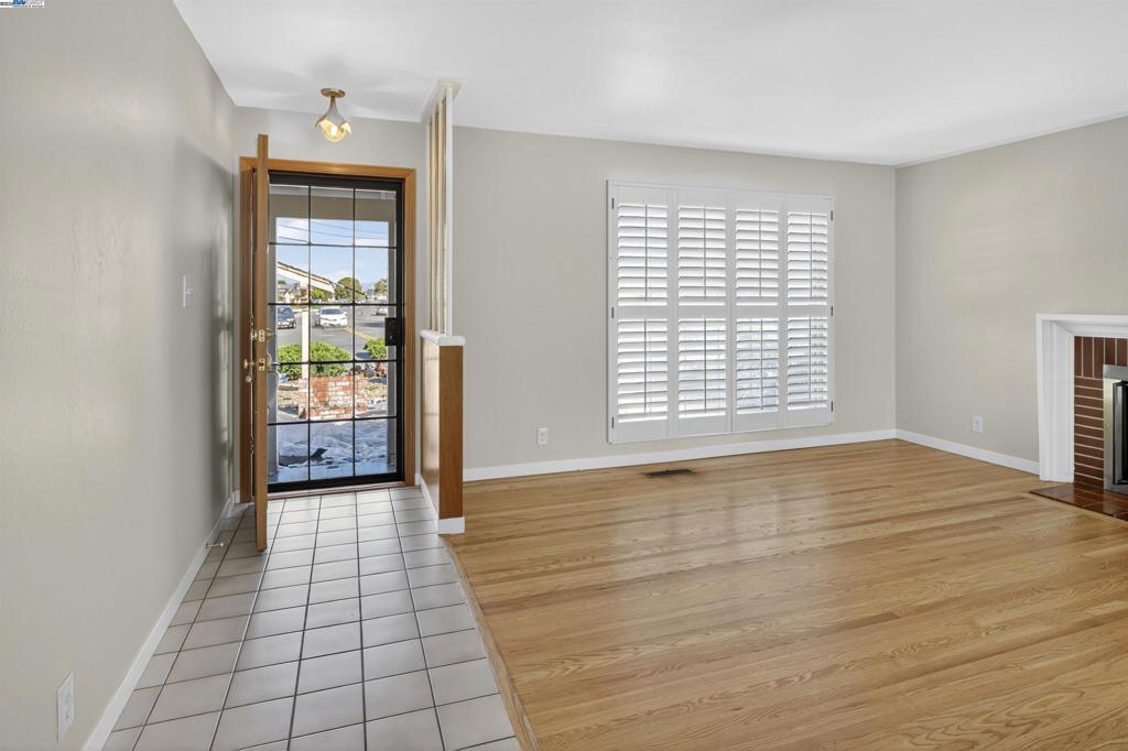 Come see this lovely home in the desirable Washington Manor area. Step inside to discover refinished hardwood floors and a cozy wood-burning fireplace that create a warm, inviting living space. The light and bright kitchen features freshly painted cabinets and plenty of storage. Additional highlights include a spacious primary bedroom suite, dual-pane windows, and classic plantation shutters throughout. Enjoy the low-maintenance, drought-tolerant front yard and relax under the covered patio in the private backyard — perfect for outdoor entertaining. With a new roof, fresh interior paint, and a convenient location close to shops, restaurants, and scenic Bay Trails, this move-in ready home is a must-see!