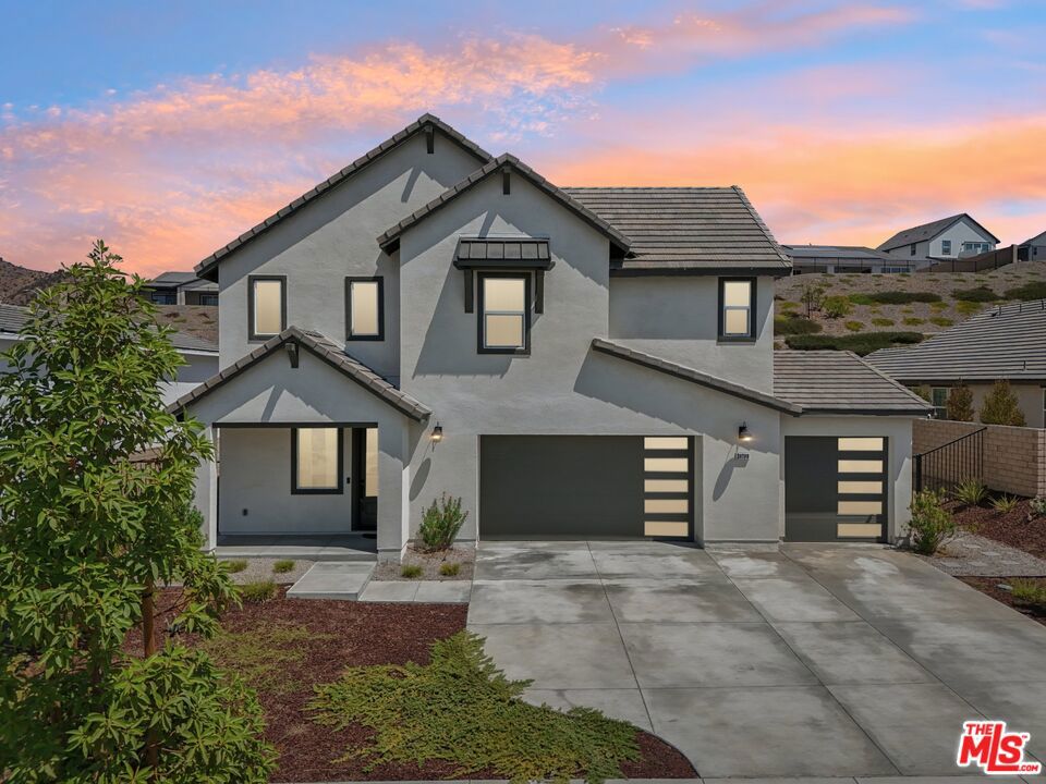 Nestled within the private gated community of Williams Ranch in Castaic, this stunning 3-bedroom, 3-bath home blends modern design with everyday comfort. From the moment you enter, you're welcomed by a formal entryway with soaring ceilings and a striking chandelier. The open-concept living space features a chef's kitchen with an oversized island, plenty of counter space, and seamless flow into the dining and living areas. A three-panel glass sliding door opens to the expansive backyard, complete with a covered patio, putting green, and ample space for relaxing or entertaining. Upstairs, you'll find a versatile loft, a dedicated laundry room, a bright and spacious primary suite with a spa-like bathroom and walk-in closet, plus two additional bedrooms and a full bath. Additional highlights include a 3-car garage, owned Tesla solar panels, and thoughtful finishes throughout. Enjoy the privacy and security of Williams Ranch while being just minutes from Lake Castaic, Valencia Town Center, schools, and easy freeway access.