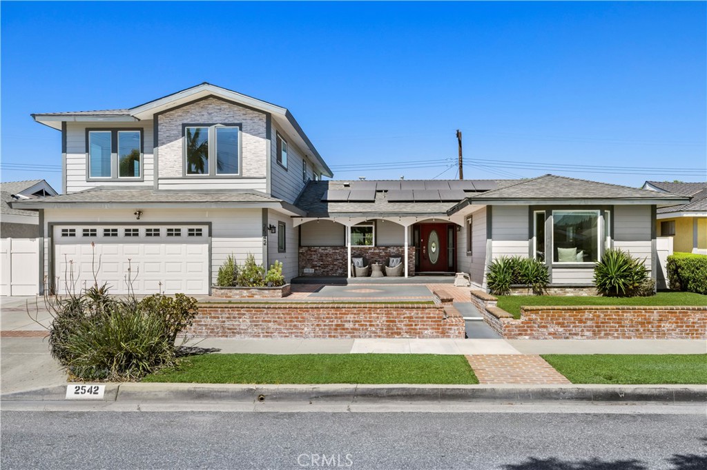 Welcome to 2542 N Ashwood Street – Where Luxury Meets Lifestyle! This beautifully remodeled 5-bedroom, 4-bathroom pool home offers nearly 3,000 sq ft of living space in the City of Orange. Every inch of this home has been upgraded with comfort, function, and style in mind. Step inside and you’ll find a spacious downstairs primary suite featuring two walk-in closets and a private ensuite bathroom. There is an inviting living room with fireplace that flows seamlessly into a formal dining area and an open-concept kitchen, complete with a large center island, extensive countertop space, and room to gather, cook, and entertain. Two additional guest bedrooms and a full bath are located downstairs, while upstairs features a bonus room with wet bar and balcony, plus two more bedrooms and another full bathroom. One of the upstairs bedrooms even includes its own walk-in closet and ensuite bath, making it ideal as a secondary suite. Step outside to your private entertainer’s backyard with a sparkling pool, built-in BBQ/kitchen, and space to host unforgettable summer gatherings. Additional features include: Leased solar for energy efficiency, Fully remodeled interior, Flexible layout for multi-gen living or working from home and 3,000 sq ft lot with great curb appeal. This home is move-in ready and ready for you to call home!