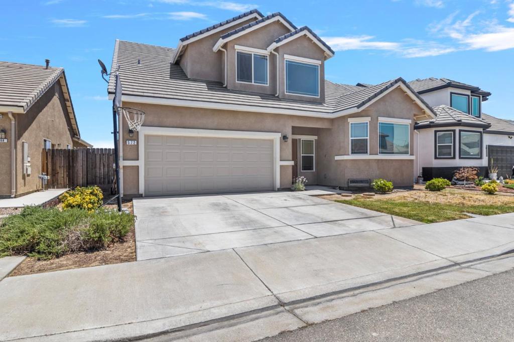 Located in the quiet and highly desirable neighborhood of Monte Vista Estates, this beautiful two-story home offers 2,034 square feet of thoughtfully designed living space. With an impressive open floor plan, soaring 20-foot ceilings, and expansive windows, the home is filled with natural light, creating a warm and inviting atmosphere. Featuring four spacious bedrooms and three full bathrooms, this residence is perfect for comfortable family living. The first floor boasts a seamless flow between the modern kitchen, dining area, and great room ideal for both everyday living and entertaining. The kitchen is equipped with shaker-style cabinetry, granite countertops, and stainless-steel appliances, including a range, microwave, and dishwasher. The primary suite is conveniently located on the main level, offering private access to the backyard through a patio door. It includes a luxurious ensuite bathroom with dual sinks, a large walk-in closet, and a spacious shower with a built-in bench. Upstairs, you'll find three additional bedrooms and a full bathroom, providing ample space for family members or guests. This exceptional home combines modern design, practical layout, and an unbeatable location dont miss your opportunity to make it yours.