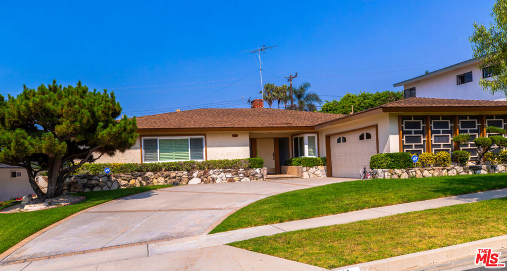 Welcome to this beautifully maintained Mid-Century single-family home located in the coveted Upper Ladera Heights neighborhood. With 3 spacious bedrooms, 4 bathrooms, and 2,451 square feet of thoughtfully designed living space, this residence exudes timeless character. Step through the wide entry door into a home where classic wood parquet flooring extends through to most of the living areas, creating warmth and continuity throughout. The living room boasts a stunning floor-to-ceiling rustic stone fireplace and a glass sliding door that leads to the private backyard, ideal for relaxing or entertaining. A separate den/family room also features a second rustic stone fireplace with a stone hearth extension that serves as a cozy focal point. This space includes a built-in wet bar with a wooden countertop, shelving, and a mirrored back, making it the perfect entertainment hub. A second glass slider provides easy access to the backyard from this room as well. The dining room, accented by an ornate chandelier, is partially open to the family room with a charming half wall, giving it a connected yet defined feel. In the galley-style kitchen, enjoy the charm of oak cabinetry in pristine condition, tiled backsplash, stainless steel sink, and a cooktop with a retractable vent and hood vent. The space also offers recessed lighting, a versatile eating area, a built-in desk with overhead storage, and a decorative ceiling fan perfect for casual meals or morning coffee. The primary suite is a true retreat, featuring large double closets, a separate vanity area with an additional sliding closet with shelving, and an en suite bath with double sinks, a soaking tub, and a separate walk-in shower. The two additional bedrooms are generously sized with ample closet space, ideal for family, guests, or home office use. Convenience continues with a large laundry room offering plenty of storage, a utility sink, and a quarter bathroom; great for multi-tasking on busy days. Step outside to the covered rear patio with a concrete slab, creating a functional outdoor living area perfect for entertaining or unwinding. The backyard offers privacy, a lush well-maintained lawn, and mature landscaping. Additional features include a 2-car garage with direct access to the home, offering both convenience and security. Don't miss the opportunity to own a classic Upper Ladera Heights gem that brings together timeless style, generous space, and an unbeatable location. Come be the newest neighbor!