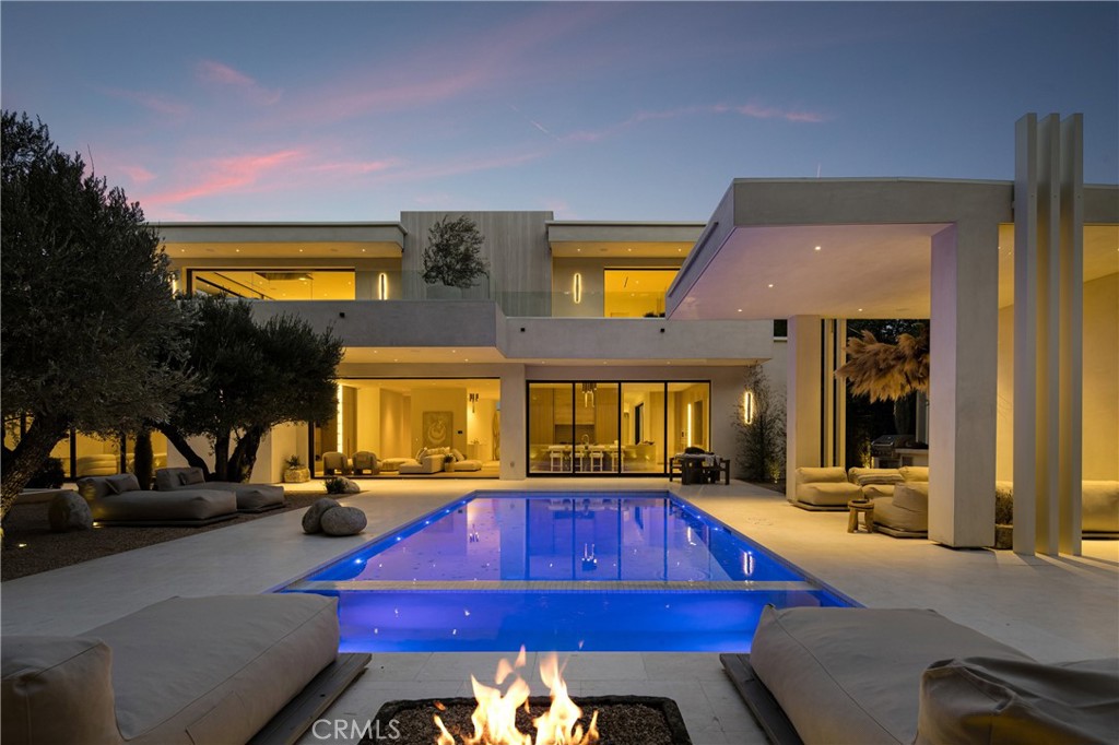 A Sanctuary Above It All...Where Architecture Meets Ascension
Welcome to 17177 Adlon Rd an architectural statement of sovereignty, soul, and sophistication.
Perched above Encino with cinematic views, this newly built estate transcends luxury and enters the realm of legacy living.
From the gated entry to the serene hillside grounds, every square foot was curated to honor privacy, flow, and future readiness. Designed for the discerning visionary, this home offers not just stunning finishes, but a resonant frequency—a place where peace is felt, not just seen.
Whether you’re seeking a private family compound, a luxury wellness retreat, or a smart investment in one of LA’s most future-resilient locations, this is your portal.
• 8,500+ sq ft of indoor serenity
• Panoramic city and canyon views with sunrise alignment
• Primary suite with spa-level energy
• Seamless indoor-outdoor living + curated landscaping
• Fully intergrated Smart home, solar, retreat-grade layout
This isn’t just a home. It’s a fortress of peace, built for what’s coming.
Prime Encino Hills with EASY WESTSIDE ACCESS and VIEWS!! VERY PRIVATE!
Breathtaking new construction that embodies the essence of luxury living—a modern Tulum-style masterpiece crafted by one of Los Angeles' most sought-after builders and designed by Yeara Design Studio.
Step outside to discover a resort-style backyard that is nothing short of a personal oasis. Dive into the sparkling outdoor pool, unwind in the soothing spa, or entertain guests under the stylish cabana complete with a full bathroom. As the sun sets, gather around the sunken fire pit, perfect for cozy evenings. The gourmet kitchen is a culinary enthusiast's dream, featuring top-of-the-line Miele appliances, custom cabinetry, and exquisite stone finishes that exude luxury. The home offers a spacious layout with a relaxing loft on the second floor, ideal for casual gatherings or peaceful retreats.
Retreat to the master suite, where a Tulum-style spa bathroom awaits, reminiscent of a five-star hotel. Every detail has been meticulously considered, ensuring an atmosphere of tranquility and elegance.
Completing this remarkable property is a generous four-car garage, providing ample space for vehicles and storage.
Located in the prestigious Encino Hills, this home offers easy access to the vibrant Westside and is close to upscale dining, shopping, and top-rated schools. Welcome home.