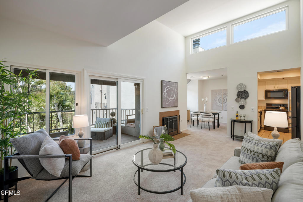Located in a secure building, this bright and inviting, light-filled top-floor unit blends comfort, style, and convenience. A tile entryway leads into freshly carpeted living spaces. To the right, a spacious bedroom features a large closet, dual-paned windows, and a solar tube for abundant natural light. A pocket door connects to a full guest-accessible bathroom with a single-sink vanity and a tub/shower combination. To the left of the entry, the primary suite offers new carpet, a built-in closet system, and an ensuite bath with an oversized floor-to-ceiling tiled shower, single-sink tiled vanity, and linen cabinets. In the hallway, a sliding mirrored door reveals a full-size stackable washer and dryer and storage shelving. The living room boasts vaulted ceilings where sunlight pours in through clerestory windows, creating a warm, uplifting atmosphere throughout. A sliding glass door from the living room leads to a spacious balcony, ideal for morning coffee, evening wine or dining al fresco. Adjacent to the living area, two skylight windows can be found in the dining area allowing more natural light to fill the space. The kitchen impresses with recessed lighting within a tray ceiling, quality KitchenAid appliances including a 5-burner gas range with a matching microwave and refrigerator. A pass-through counter to the dining area, makes both everyday meals and entertaining a joy. Moments from Pasadena City College, Caltech, the Metro Rail, and all of Pasadena's dining, shopping, and cultural attractions, this home offers the ideal combination of location and livability.