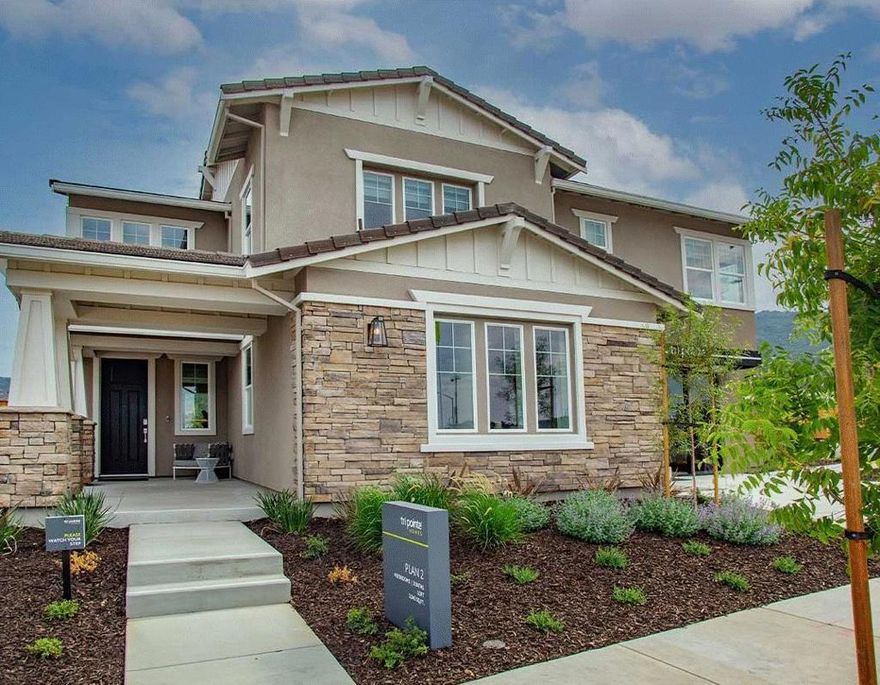 Homesite 49 | Plan 2. Fully furnished model home featuring 4 bedrooms and 3 baths in approximately 3,045 sq. ft. This two-story Craftsman-style home offers a reverse floorplan with a main-level bedroom and full bath, open-concept Great Room with gas fireplace, and a gourmet chefs kitchen with quartz countertops, island with sink, pot filler, walk-in pantry, and high-end appliances including wine fridge. Upstairs, the loft includes built-in cabinets and desks, and the Primary Suite offers oversized tub, stall shower, walk-in closet, and laundry access. Enjoy multiple outdoor spaces with fenced backyard, balcony, outdoor kitchen, and barbecue area. Additional highlights include multi-zone HVAC, tankless water heater, smart home system, and attached 3-car garage with Level 2 EV hookup capability. Brix at Glen Loma Ranch is a hillside community with parks, trails, and scenic views, offering a serene lifestyle while close to Gilroy amenities. Photos are of the actual home.