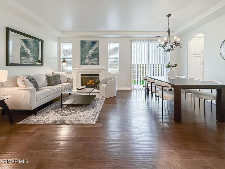 Welcome to this beautifully updated home offering 4  bedrooms, 2.5 baths, and a spacious bonus room perfect for everyday living. A soaring cathedral ceiling at the entry and gorgeous wood flooring throughout create a warm, inviting atmosphere.  Thoughtful details such as designer paint, ceiling fans, and custom touches combine style with comfort.  The formal dining room, highlighted by a chandelier and sliding doors to the side yard, flows seamlessly into the living room with a cozy fireplace.  The gourmet kitchen showcases an extended center island, elegant quartz counters, sleek white cabinetry, and a farmhouse sink - opening to the family room complete with a second fireplace, making it the ideal gathering spot. Upstairs, the primary suite offers a true retreat with dual closets featuring custom built-ins and a spa-inspired bathroom with dual vanities, soaking tub, and separate shower.  Three additional bedrooms, a generous bonus room, and convenient upstairs laundry complete the second level. Enjoy the private backyard with picturesque mountain views, a covered patio, lush landscaping, and a spacious grassy area - perfect for entertaining or relaxing.  A 3-car garage with built-in cabinets provides ample storage.  Located in a prime neighborhood, close proximity to Sycamore Canyon K-8 School, parks and The Village. Exceptional!