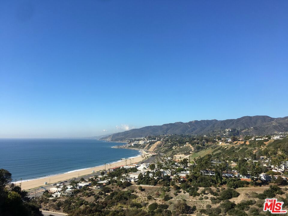 A rare and remarkable opportunity to build your dream home on one of the most coveted bluff-top locations in Pacific Palisades. Formerly the site of a stunning Architectural style residence, built in 2022, this 8,000 SF lot sits on the prestigious Via Bluffs park, offering unobstructed ocean and mountain views, and close proximity to Palisades Village and the sea. The previous home, designed and built by acclaimed team David and Eliana Rokach, was lost in the January 2025 fires, presenting a blank canvas for a new vision in one of L.A.'s most desirable neighborhoods. The lot previously featured approximately 6,000 SF of living space, in 3 levels with 5 bedrooms, 5.5 bathrooms, a basement level with natural light, featuring a gym, a home theater and wine cellar, an infinity-edge pool, and a 1,500+ SF rooftop deck with a hot tub proof of the site's unique potential for scale and luxury. The seller is in the process of obtaining the permits for the house, as it existed before, and the first phase of clean-up has been completed. Whether you're an end-user looking to create a custom coastal masterpiece or a developer seeking a blue-chip opportunity, this is your chance to secure a piece of the Pacific Palisades bluff with panoramic ocean views and endless possibilities.