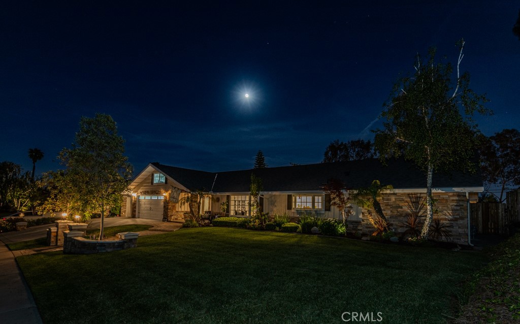 Welcome to 1448 W Domingo Rd in Fullerton, a beautifully upgraded single-story home in the highly desirable Sunny Hills neighborhood. This home sits on a private lot just under half an acre, offering space, comfort, and incredible outdoor living. From the moment you arrive, you’re welcomed by paver walkways, a double-door entry, and charming stacked stone accents. Inside is a foyer that opens to a spacious living room with a large bay window providing great natural lighting, wood flooring, and recessed lighting. The kitchen is tastefully updated with granite counters, an island, stainless steel appliances, upgraded cabinetry, recessed lights, a bay window, and a pantry. The dining area has a ceiling fan and French doors with operable side panels opening to the backyard. To the left of the entry, the large family room has a brick fireplace, recessed lighting, and another set of French doors with side windows that open, creating great indoor-outdoor flow. The covered patio is an entertainer's dream. Both ends of the patio feature recessed lights and dual ceiling fans. It’s wired for a wall-mounted TV and set up for outdoor entertaining. The stainless steel barbecue can connect to a gas line and sits near the paver-lined entertaining area. The pool and spa include a diving board and multiple waterfalls that flow into the pool. The spacious yard also includes a large grass area and is surrounded by mature trees for enhanced privacy and relaxation. All bedrooms and living spaces have wood flooring, while the kitchen, bathrooms, and dining area feature large tile flooring. The primary bedroom has double-door entry, a walk-in closet, plantation shutters, and a ceiling fan. The remodeled bathroom features granite counters, custom cabinetry, recessed lights, and a walk-in tiled shower. The guest bathroom has dual sinks, custom cabinetry, and a tiled shower combo. Not included in the square footage is an upstairs bonus area with an office nook and open media space. The finished two-car garage has direct access and epoxy flooring. A wide driveway provides room for multiple cars. All windows have been replaced, solar with 33 panels is paid off, the electrical panels have been updated, and the home is in excellent condition. Zoned for some of Fullerton’s top-rated schools including Laguna Rd and Sunny Hills, this location is ideal for anyone seeking access to top-tier education. Rare chance to own this beautiful home in one of the best neighborhoods in the city.