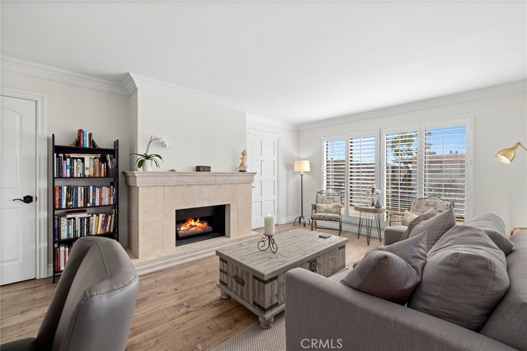 Just two blocks from the enchanting beaches and coves of North Laguna Beach, this stylishly upgraded condominium offers the enviable versatility of enjoying it year-round, as a prized vacation getaway, or an outstanding investment opportunity. No matter how you prefer to utilize the light and airy residence, it impresses with an upgraded interior that captures coastal elegance and embellishes it with custom crown molding, plantation shutters and wood-inspired plank flooring. A graceful fireplace with mantle and raised hearth warms the living room, which opens to a covered deck that welcomes outdoor relaxation and small get-togethers. Two bedrooms and two upgraded baths include a primary suite with walk-in closet, and a newer kitchen shines with granite countertops, white cabinetry with glass uppers, and stainless steel appliances. Approximately 879 square feet, the single-level design is located on the first floor and includes an enclosed garage with room for storage. The condo’s excellent setting makes it easy to leave the car at home and explore North Laguna’s extensive variety of galleries, boutiques and restaurants.