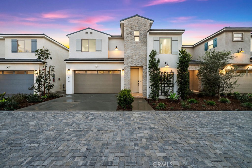 Experience the best of new construction living at Jazmin at Orizaba, where modern design meets comfort and efficiency. This thoughtfully crafted home offers contemporary style, smart technology, and energy-efficient features in an exclusive new community in the heart of Paramount, California. This Plan A home offers 4 bedrooms, 2.5 bathrooms, and 2,078 square feet of thoughtfully designed living space. Adjacent to LA KINGS Iceland, it blends contemporary elegance with modern efficiency in a desirable neighborhood.
Designed for comfort, it features 9-foot ceilings for an open, airy feel. The kitchen is equipped with custom-built cabinetry, premium appliances, quartz countertops and designer-selected finishes. Thoughtful details, including shiplap and board-and-batten accents, enhance the home’s character, while luxury vinyl plank flooring adds durability and style. The spacious primary suite features a walk-in closet and a beautiful ensuite bath, while the upstairs laundry room provides additional convenience.
This home is designed with modern convenience in mind, featuring smart home technology including a Wi-Fi-enabled thermostat, keyless entry, integrated security system with cameras, smart lighting, and built-in Ubiquiti WiFi access points. The attached garage offers durability and functionality with epoxy flooring, an EV-ready charging outlet, and a Wi-Fi-enabled garage door opener for seamless remote access.
Additional features include custom cabinetry, with integrated storage solutions such as built-in desks, linen storage, and custom closet organization to maximize space and minimize clutter. A fire sprinkler system adds an extra layer of safety. Built for sustainability and energy efficiency, this all-electric home supports cleaner energy use through the integration of solar panels and renewable energy sources, reducing utility costs and reliance on fossil fuels.
The outdoor space is thoughtfully landscaped with a concrete patio, turf, and planter areas, ideal for entertaining or relaxing. Located near Paramount City Hall, the Civic Center, shopping, dining, a hospital, and the library, this home is perfectly situated in a quiet residential setting with easy access to major freeways, providing seamless connectivity to Orange County and Los Angeles.
No HOA. No Mello-Roos. Experience the perfect blend of modern luxury, smart technology, and energy efficiency at Jazmin at Orizaba.