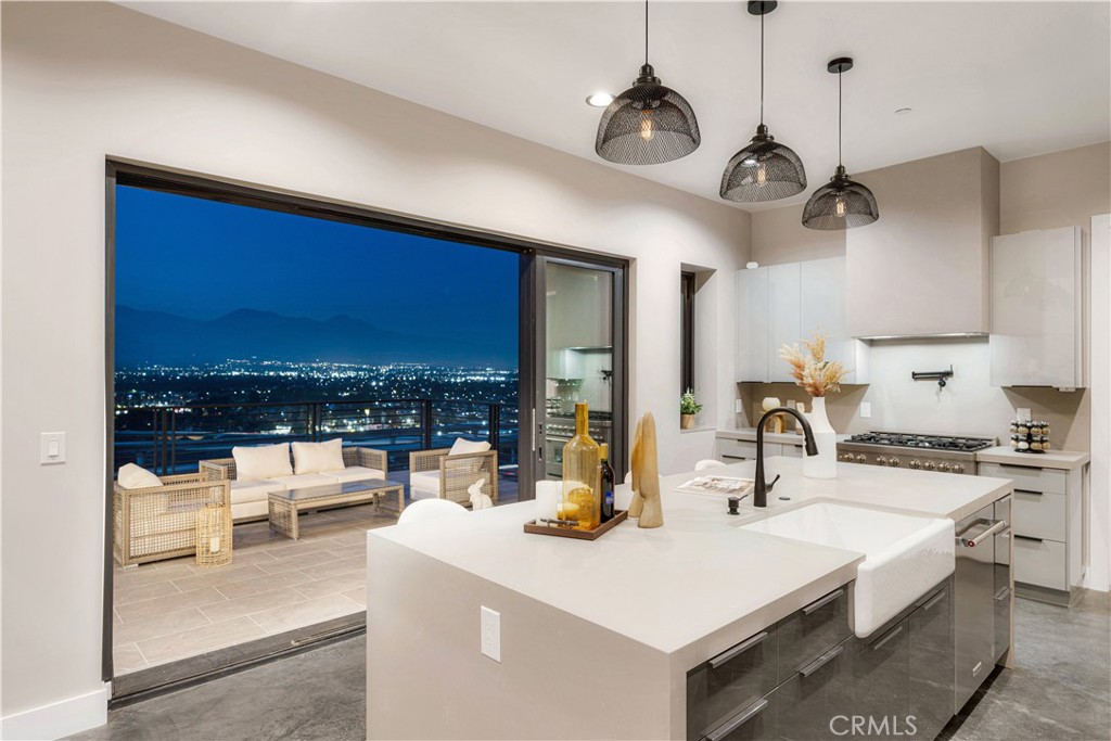 --Seller Financing Available-- New Built View Custom Home – Nestled in a prestigious hillside enclave on the highly sought after Scenic Ridge Dr in North Chino Hills—ranked among California's safest cities—this 2025 Toll Brothers-style modern luxury estate offers panoramic views, convenience, and refined living.
Perched above rolling hills among custom estates, the home captures sweeping 180° vistas from Mt. Baldy to Big Bear—an ever-changing canvas from sunrise to city lights, spring blooms to winter snow. Every window frames moments of beauty—twinkling lights, hawks gliding, or distant traffic. The ordinary becomes cinematic.
Step through oversized doors into a soaring 19-ft foyer, where walls of glass flood the space with light and highlight the views. The 3,050 sqft residence on a 13,554 sqft lot features seamless indoor-outdoor living. Wraparound decks extend living space, while a private front courtyard sets a serene tone.
This 5-bedroom, 4.5-bath home includes a main-floor en-suite plus four upstairs bedrooms—featuring a luxurious primary suite, another en-suite, and two sharing a bath—ideal for multi-gen living or guests. The kitchen features sleek gray cabinetry, a 6-burner stove, and industrial-style flooring. Bathrooms showcase designer tilework and high-end finishes. The primary suite offers a walk-in closet, views, and a spa-inspired bath with marble tile and gold fixtures.
A modern steel-framed staircase leads to a bridge-style landing overlooking the great room. The finished 650 sqft garage offers flexibility. The oversized driveway provides ample parking and space for a future pool, guest house or garden oasis.
Convenience meets luxury with proximity to great schools, The Shoppes, Costco, Sprouts, Trader Joe’s, 99 Ranch, H-Mart, hiking trails, horse back riding trails, Chino Hills State Park, and bordering Orange County, Riverside County, San Bernardino County with easy access to FWY 60, 71, 57, 10 and 91. Over 50% holding bachelor/ graduated degree and 30% earning $200,000+ annually. Coming in 2026: a 61,000 sqft T&T Supermarket-—Canada’s #1 Asian American grocery—signifying the city’s continued growth.