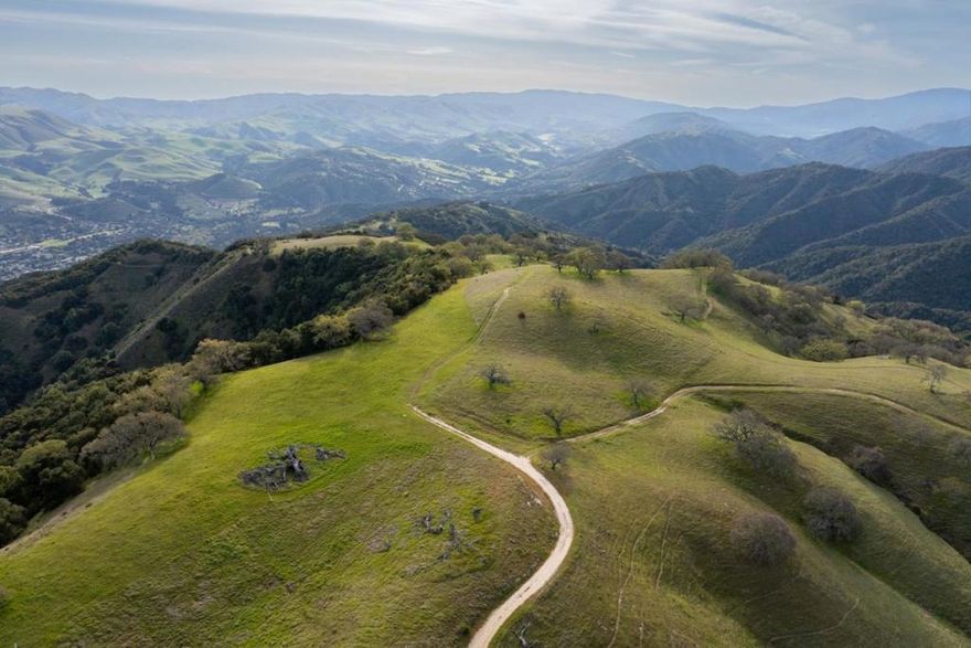 Perfectly situated atop a knoll behind secured gates of the Santa Lucia Preserve, rests this breathtaking 24+- acre homesite with ocean, mountain, and valley views. The very flat and usable 2.3+- acre building envelope allows for a single-level main house, guest cottage, ADU, barn (for horses, cars or other recreation), and part-time equestrian. Located a short distance from the renowned Tom Fazio-designed golf course, the Equestrian Center, fitness facility, pool, and over 100 miles of private trails, this homesite seamlessly blends convenience with tranquility. Here, within this 20,000-acre gated community, limited to just 300 owners, every day offers an opportunity to connect with nature, neighbors, and the best of Preserve living. Security, water, roads, electrical conduits, cell coverage, fast fiber optic internet and fire management infrastructure are all in place ready for you, along with the convenience of resident services provided by the homeowners association. Now is the time to build your dream home in this world class community.