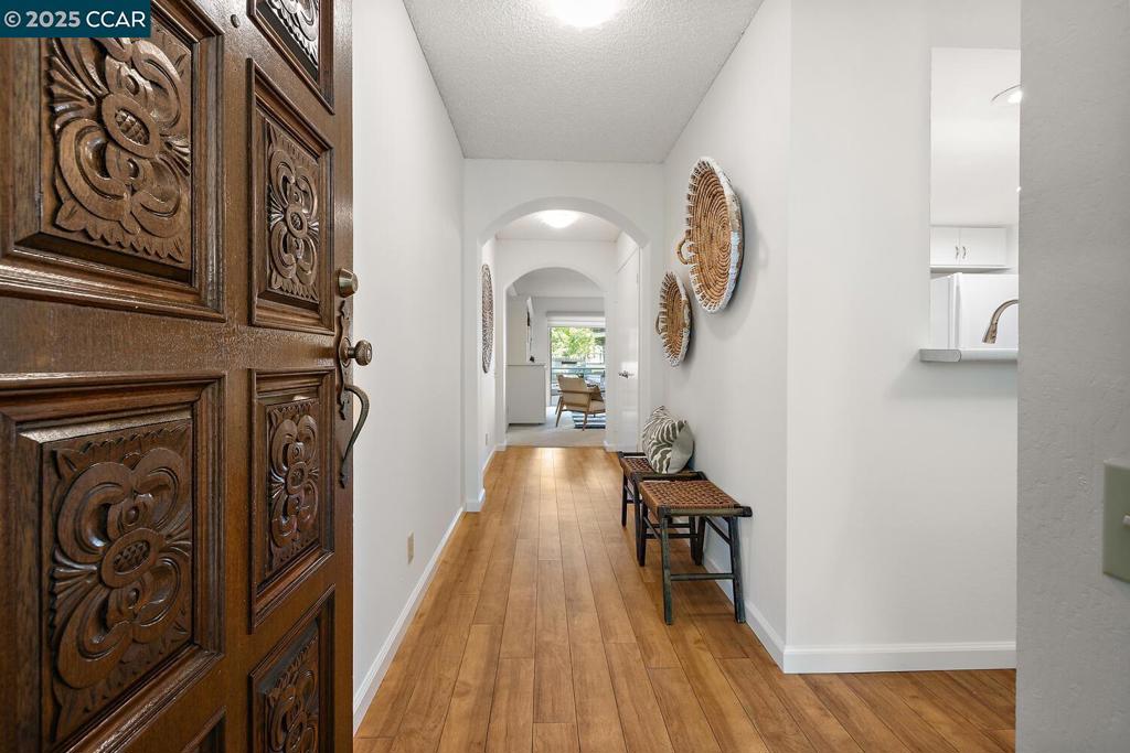 Welcome to the Villa Cordova, a level-in condo in Rossmoor. This spacious two bedroom home is on the ground floor so you have no steps from your carport to your front door, making it accessible for all. Inside this spacious home you'll find almost 1,150 square feet of pristine living space just ready for you to move in. The Kitchen has been updated with modern white cabinetry and sleek countertops and is open to a large Dining Area for easy access to all your meals. A large built-in shelving system in the Living Room makes creating your own entertainment center or personal library a breeze and the huge walk-in closet with custom shelving gives you plenty of room for all your personal items. The Bathroom has a roomy stall shower with multiple shower heads, two separate vanity areas, and a deep reach-in closet for all your home essentials. Laundry is easy with a stacked washer/dryer in the laundry room that doubles as a pantry with lots of shelving. This property looks out at one of the rare private pools in Rossmoor that is shared with just a small number of residents in the area, meaning you are just a couple of steps away from enjoying a cool dip on a hot day. Don't miss this great opportunity for a level-in Rossmoor home at an amazing price!