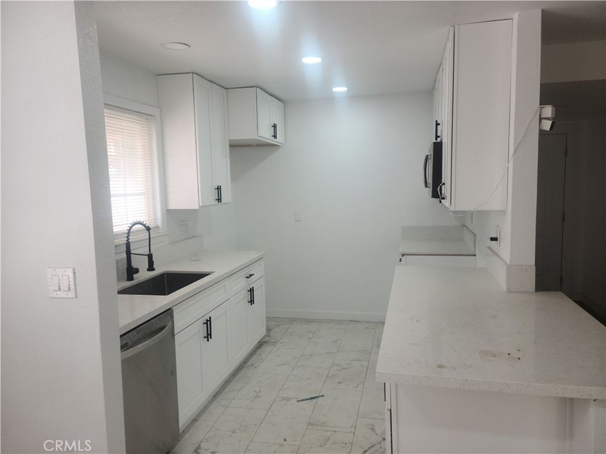 WOW Welcome home! Completely remodeled home with all new white kitchen cabinets, quartz counters and stainless steel appliances. Bathrooms all updated with New tile shower and tub walls and flooring. House is a 4 bedrooms and 2 baths with additional small room perfect for office or guest room. All luxury vinyl water proof planks flooring. NEW ROOF! Copper plumbing . Updated Panle. Dual glazed windows. Garage has new bathroom, insulated walls and all the plumbing for to make a kitchen.  Perfect for adult kids or rental income.