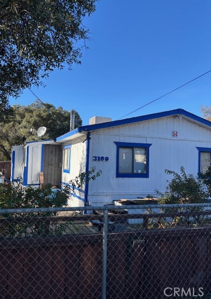 Great Price for this Maintained 2 bedroom, 2 bath manufactured home on a fenced lot. Chicken coop in back and a workshop and lots of storage. The Living room has a wood burning stove and the washer and dryer can be included. Add on porches on each side, make this well insulated. Paved street. Country solitude!