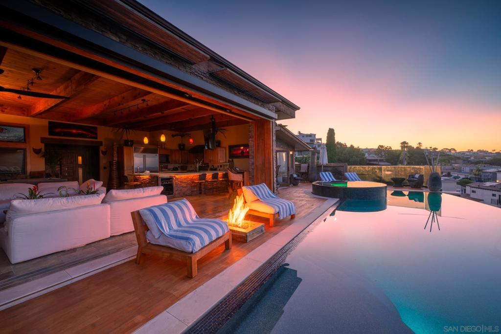 Your private resort awaits! This stunning 4 bedroom, 4 and 1/2 bath home is neslted in one of San Diego's most coveted hilltop neighborhoods offering breathtaking 180 degree south west facing views of the Pacific Ocean, Mission Bay, Downtown and all the way to Mexico! Enter into your new home overtop a bridged koi pond and open the Polenysian inspired entrance into the open entertainer's great room and Kitchen. In front of you will be 20 foot sliding glass wall where your infinity edge pool & Spa await you. Other features of this resort inspired home are; Sauna, two steam showers, Putting Green, Custom Wine Closet, Saltwater Fish Tank, Full weight rack in the Garage. This property comes fully furnished with high end pieces from Restoration Hardware.