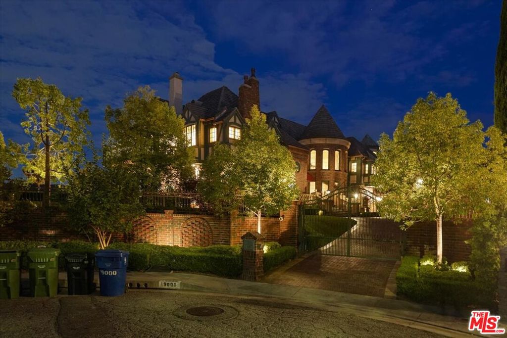 Do not call the owner: Re-listing property. English Tudor Tennis Estate in Tarzana Hills! This stunning, one-of-a-kind luxury gated Estate is a unique sanctuary fully furnished and ready for move-in immediately. A secure, private, and sprawling property on 2 Lots totaling over 4+ Acres on a secluded cul-de-sac with a magnificent home of approximately 8,700 square feet plus additional indoor/outdoor spaces with breathtaking unobstructed views. A striking two-story entry with a free-standing curved wood stairway is complemented by an authentic hand-distressed walnut hardwood floor leading to a luxurious step-down living room with vaulted ceilings and French doors. Upstairs, the elegant master suite is accentuated by a fireplace, French windows with automated drapery, a large private balcony, and a foyer sitting room with hardwood walnut plank flooring. The Master Bath features custom marble, heated flooring with 'His & Hers' amenities, including two sinks, two toilets, an oversized steam shower for two, and a large, jetted soaker tub. The sprawling grounds offer complete privacy with expansive views of the San Fernando Valley. Amenities include a pool, Loggia, Gazebo, Tennis Court, a formal English Garden, a slope-side orchard, and an outdoor dining Pavilion overlooking the adjacent private golf course.
