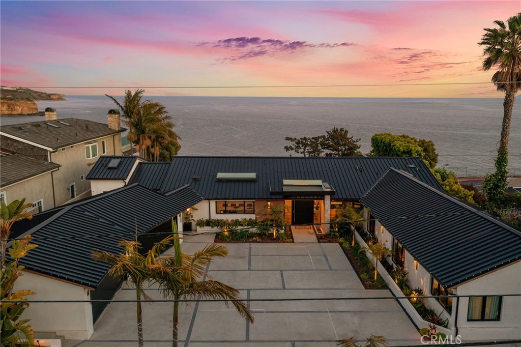 Stunning Oceanfront Estate on the Bluffs of Rancho Palos Verdes. Designed by distinguished architect Luis de Moraes, this home was brought down to the studs and completely re-imagined less than 2 years ago.
Perched majestically above the Pacific on the dramatic cliffs of Rancho Palos Verdes, this extraordinary estate offers coastal living at its finest. With breathtaking, unobstructed ocean views from nearly every room, this 4-bedroom, 4.5-bathroom residence combines timeless elegance with modern luxury, all set on over one acre of prime bluff-top land.
Inside, exquisite finishes and impeccable craftsmanship define the home—from soaring ceilings and wide-plank hardwood floors to and designer lighting. The expansive living spaces are flooded with natural light and open effortlessly to outdoor terraces, creating a seamless indoor-outdoor lifestyle. The gourmet kitchen is a chef’s dream, outfitted with high-end appliances, custom cabinetry, and a large center island perfect for entertaining.
The primary suite is a private retreat, featuring panoramic ocean views, a spa-inspired bath, and large walk-in closets. Each of the additional bedrooms is generously sized and en-suite, providing comfort and privacy for family or guests. The home also has a large 4 car garage.
Set apart from the main home is a dedicated gym room situated right at the edge of the bluffs—an inspiring space to work out with the sound of waves crashing below. The expansive grounds offer multiple patios, manicured landscaping and a pool and spa where you have panoramic views of the magnificent Palos Verdes coastline. This property ideal for both quiet reflection and grand-scale entertaining.
This is a rare opportunity to own an iconic piece of California coastline—where every sunset feels like a private show, and the ocean is your closest neighbor. The home is sold completely furnished.